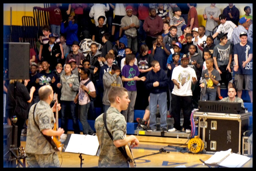 Fully involved with the Feb. 29, 2012 performance, students at Pontiac Jr High boogie down to rock music provided by NCOIC and guitarist MSgt Jerry Kelley, audio engineer MSgt Dan Kenemore and A1C Andy Detra of the Air Force Band of Mid-America "Starlifter."  Starlifter encouraged students toward honesty and Air Force core values to strengthen their futures.  (Photo courtesy/Michelle White)