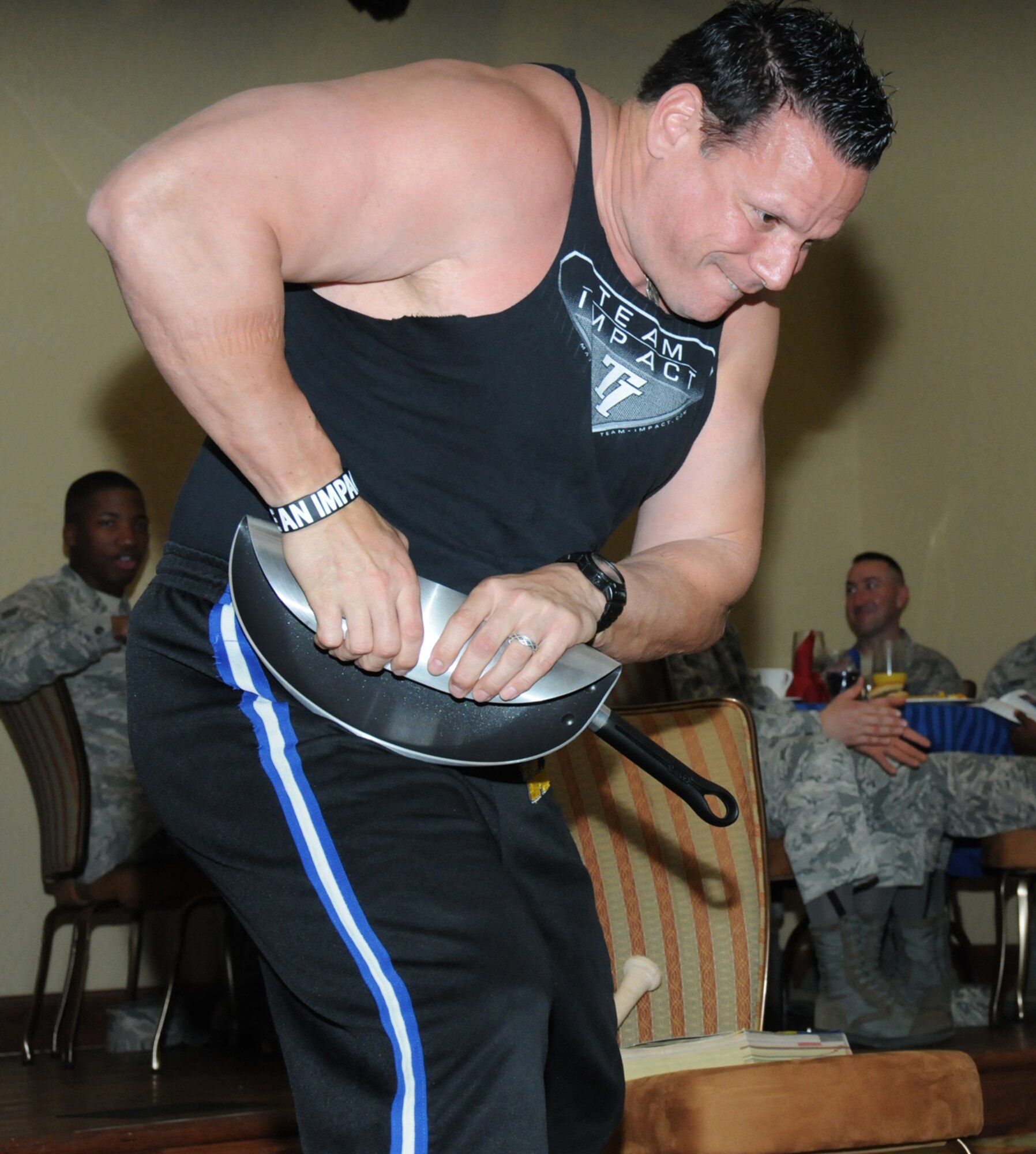 Jeff Neal, Team Impact leader, rolls a frying pan during  the team’s performance at Keesler’s National Prayer Breakfast ceremony March 6, 2012, at the Bay Breeze Event Center, Keesler Air Force Base, Miss.  (U.S. Air Force photo by Kemberly Groue)
