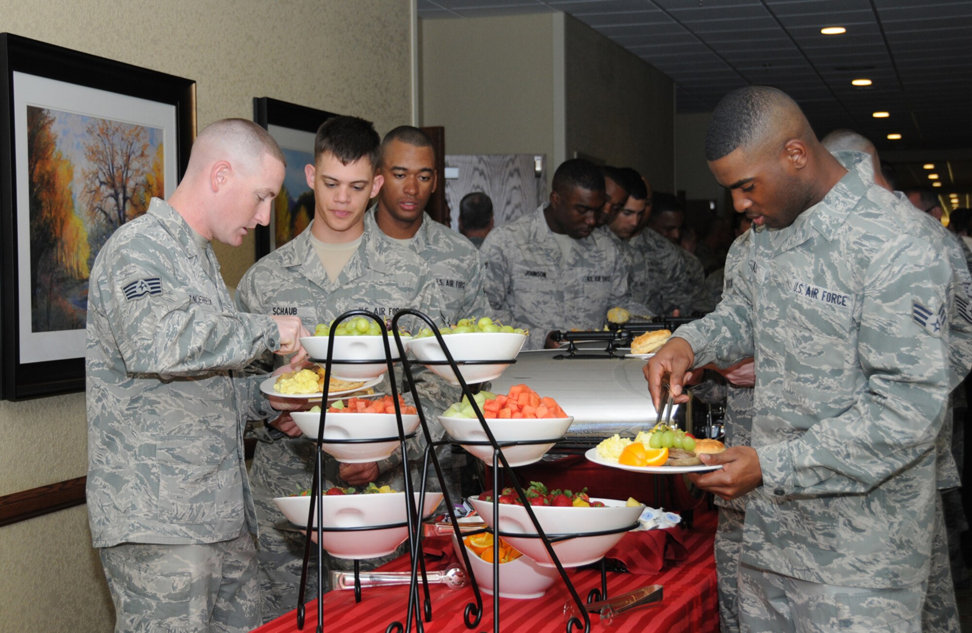 United States Air Force Honor Guard Drill Team members fill their plates at the buffet line during the National Prayer Breakfast ceremony March 6, 2012, at the Bay Breeze Event Center, Keesler Air Force Base, Miss.  The drill team did a four-man drill performance during the ceremony.  (U.S. Air Force photo by Kemberly Groue)