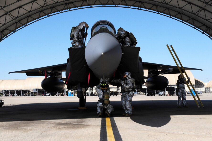 Firefighters from the 4th Civil Engineer Squadron fire emergency services flight make sure all systems of an F-15E Strike Eagle are turned off  due to a simulated fire during exercise Coronet Warrior 2012 on Seymour Johnson Air Force Base, N.C., March 7, 2012. The jet’s systems must be shut off during a fire so the aircrew can be safely removed and to help prevent the fire from spreading. (U.S. Air Force photo/Airman 1st Class Mariah Tolbert/Released)