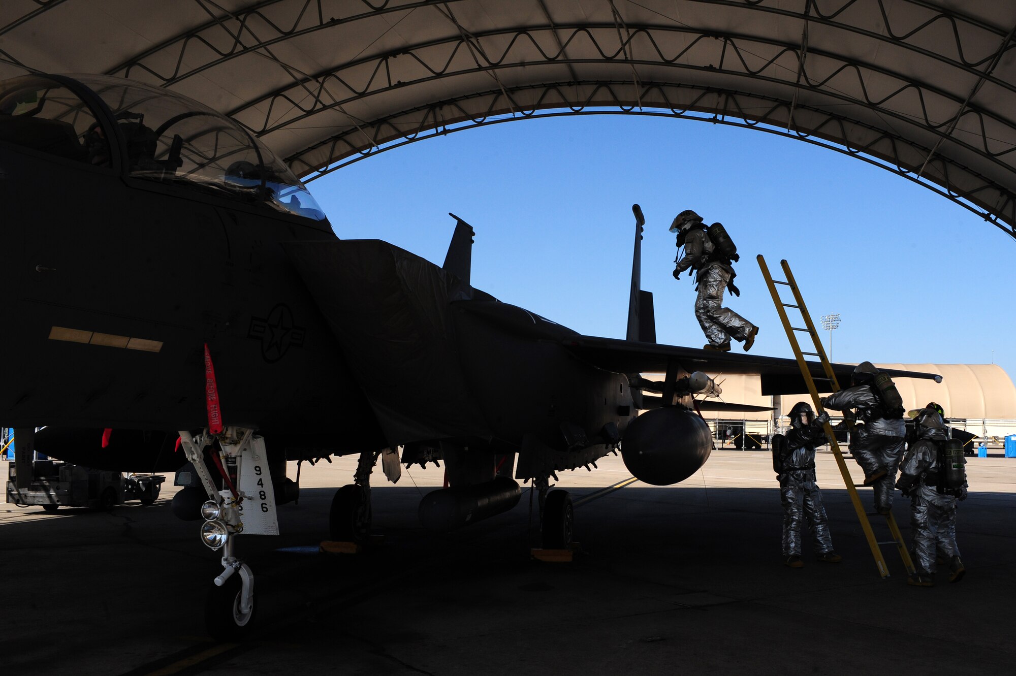 Firefighters from the 4th Civil Engineer Squadren fire emergency services flight prepare to evacuate an aircrew from an F-15E Strike Eagle due to a simulated fire on as part of exercise Coronet Warrior 2012 on Seymour Johnson Air Force Base, N.C., March 7, 2012. The exercise and additional F-15E Strike Eagle flying ensures base Airmen are prepared to support overseas contingency operations and effectively complete the mission of the 4th Fighter Wing; to provide Strike Eagle airpower, on target, on time for America. (U.S. Air Force photo/Airman 1st Class Mariah Tolbert/Released)