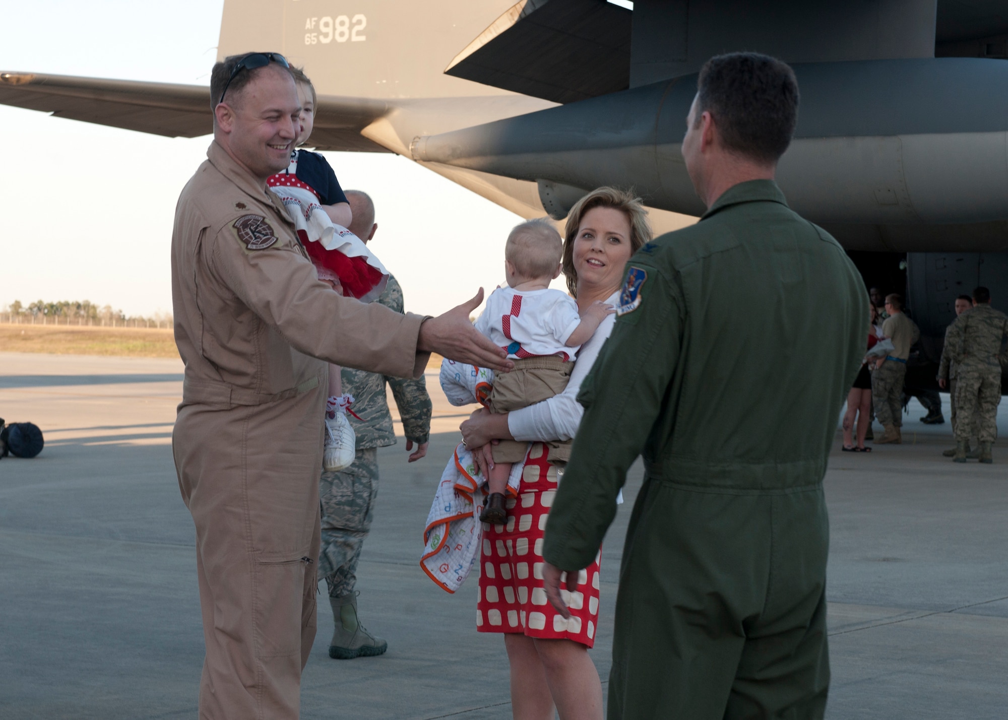 U.S. Air Force Maj. Jeremy Dickey, 71st Rescue Squadron, and his family receive greetings from Col. Chad Franks, 347th Rescue Group commander, after returning from deployment Mar. 5, 2012, at Moody Air Force Base, Ga. The 71st RQS air crew and other Moody Airmen from different units spent four months in Camp Bastion, Afghanistan, in support of Operation Enduring Freedom. (U.S. Air Force photo by Senior Airman Eileen Meier/Released)

