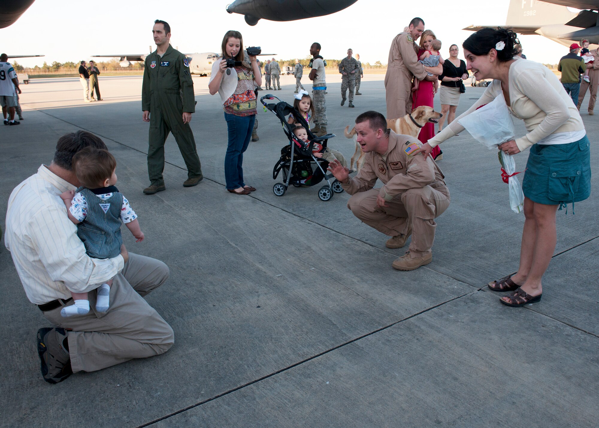 U.S. Air Force Capt. Edward Wineland, 71st Rescue Squadron, greets his son after a four-month deployment to Camp Bastion, Afghanistan, in support of Operation Enduring Freedom, Mar. 5, 2012, at Moody Air Force Base, Ga. He and about 50 other Airmen returned on an HC-130P Hercules where family, friends and base leadership anticipated their arrival. (U.S. Air Force photo by Senior Airman Eileen Meier/Released)