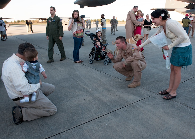 U.S. Air Force Capt. Edward Wineland, 71st Rescue Squadron, greets his son after a four-month deployment to Camp Bastion, Afghanistan, in support of Operation Enduring Freedom, Mar. 5, 2012, at Moody Air Force Base, Ga. He and about 50 other Airmen returned on an HC-130P Hercules where family, friends and base leadership anticipated their arrival. (U.S. Air Force photo by Senior Airman Eileen Meier/Released)