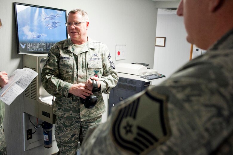 Chief Master Sgt. Thomas Powner, a 910th Civil Engineer Squadron fire chief, comments on his experience with combat arms training during a 30-year career that involved five deployments to Iraq and Afghanistan. 910th Combat Arms Training and Maintenance conducts weapons courses each Unit Training Assembly in preparation for the 2013 Operational Readiness Inspection and to meet training requirements. U.S. Air Force photo by Eric M. White.