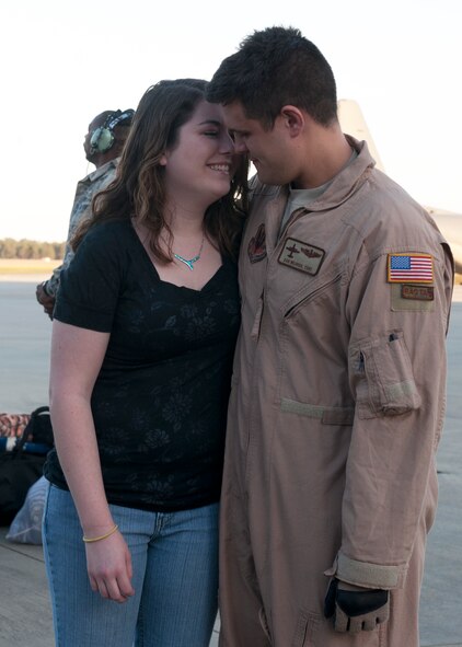 U.S. Air Force Tech. Sgt. Daniel Weaver, 71st Rescue Squadron, embraces his wife after returning from a four-month deployment Mar. 5, 2012, at Moody Air Force Base, Ga. Airmen with the 71st RQS and other Moody squadrons returned home from Bastion, Afghanistan, in support of Operation Enduring Freedom with warm welcomes from base leadership, family, friends and even pets. (U.S. Air Force photo by Senior Airman Eileen Meier/Released)