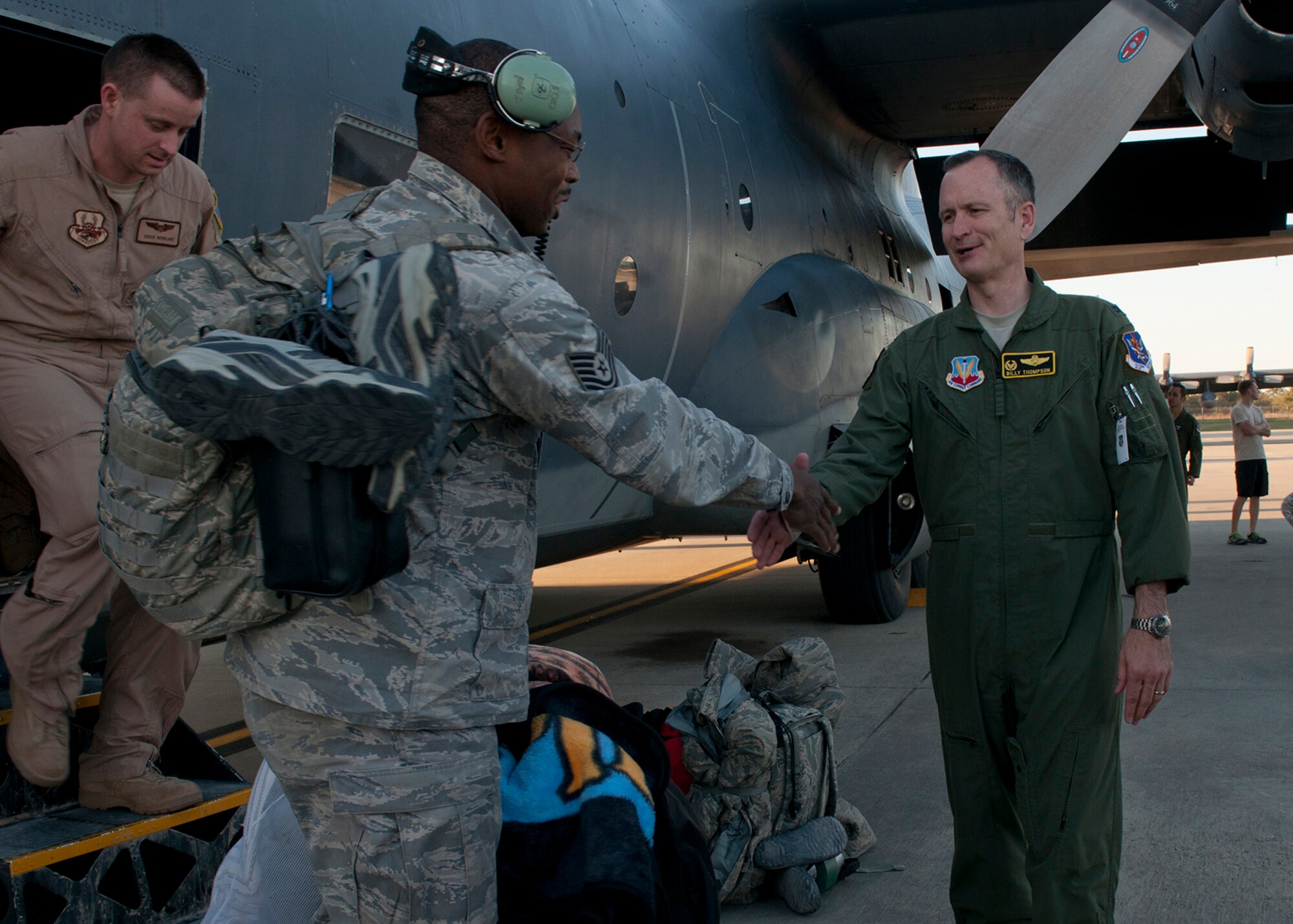 U.S. Air Force Col. Billy Thompson, 23d Wing commander, and other base leadership welcome home Tech. Sgt. Jonathan Byrd, 723d Aircraft Maintenance Squadron, with a handshake as he steps off of an HC-130P Hercules that safely transported Moody Airmen from their deployment location Mar. 5, 2012, at Moody Air Force Base, Ga. The team left in November of 2011 to Camp Bastion, Afghanistan, in support of Operation Enduring Freedom. (U.S. Air Force photo by Senior Airman Eileen Meier/Released)