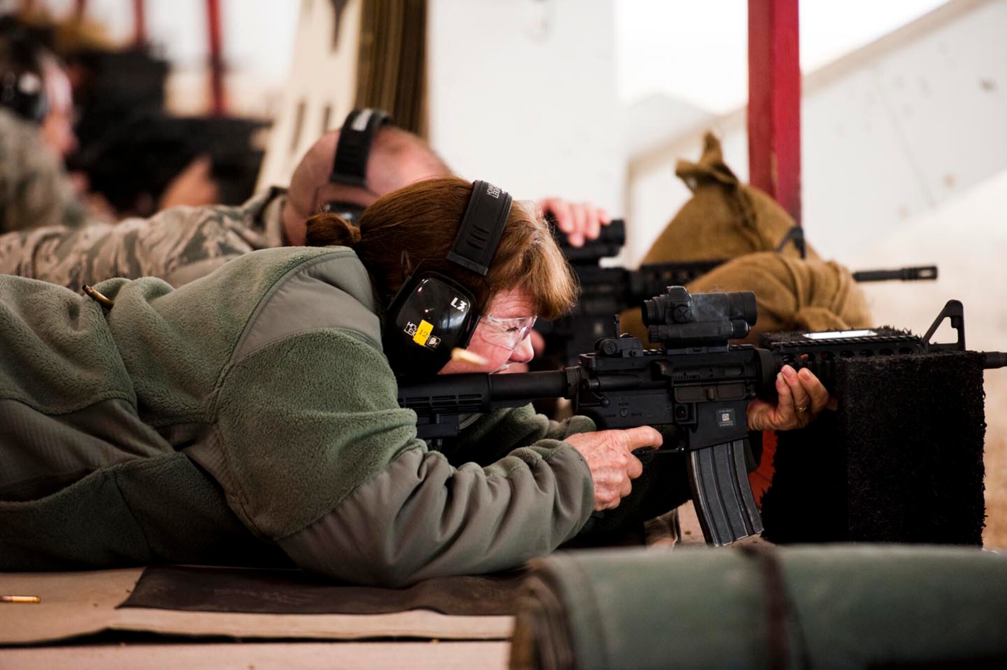 Master Sgt. Karen Satterfield, 910th Civil Engineer Squadron pavements and equipment supervisor, fires an M4 rifle at the firing range, here, March 3, 2012. 910th Combat Arms Training Maintenance conducts weapons courses each Unit Training Assembly in preparation for the 2013 Operational Readiness Inspection and to meet training requirements. U.S. Air Force photo by Eric M. White.