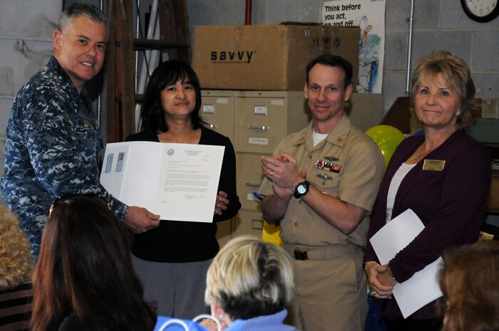 Cmdr. Charles Phillip presents a Superior Accomplishment Recognition Award to Josefina Gaza as Master Chief Petty Officer Billy Cady and Beth Munoz congratulate her during a Navy Exchange luncheon at Joint Base Charleston - Weapons Station Mar. 6. The NEX luncheon celebrated the stores fiscal year 2011 sales of more than $30 million and recognized the individual contributions of NEX employees in achieving this milestone. Phillip is the 628th Mission Support Group deputy commander, Gaza is an NEX employee,  Cady is the JB Charleston – Weapons Station command master chief and Munoz is the Charleston NEX general manager. (U.S. Navy photo/Petty Officer 2nd Class Brannon Deugan)