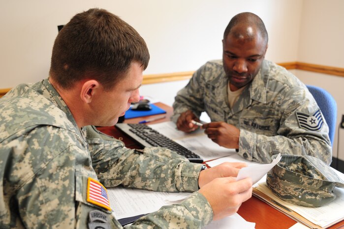 Tech. Sgt. Lawrence Williams reviews Army Lt. Col. Kevin Wissel's paperwork prior to preparing his taxes at the Joint Base Charleston - Air Base Volunteer Income Tax Assistance office Mar. 7. The VITA office provides free tax preparation services at JB Charleston - Air Base from 8 a.m. to 3 p.m., Monday through Friday and is available by appointment only. The JB Charleston - Weapons Station VITA office offers walk-in service from 9:30 a.m. to 7:30 p.m. Monday through Friday. Williams is the VITA site coordinator for the JB Charleston - Air Base tax office and Wissel is the U.S. Army Corps of Engineers Charleston District deputy district engineer. (U.S. Air Force photo/Staff Sgt. Katie Gieratz) 