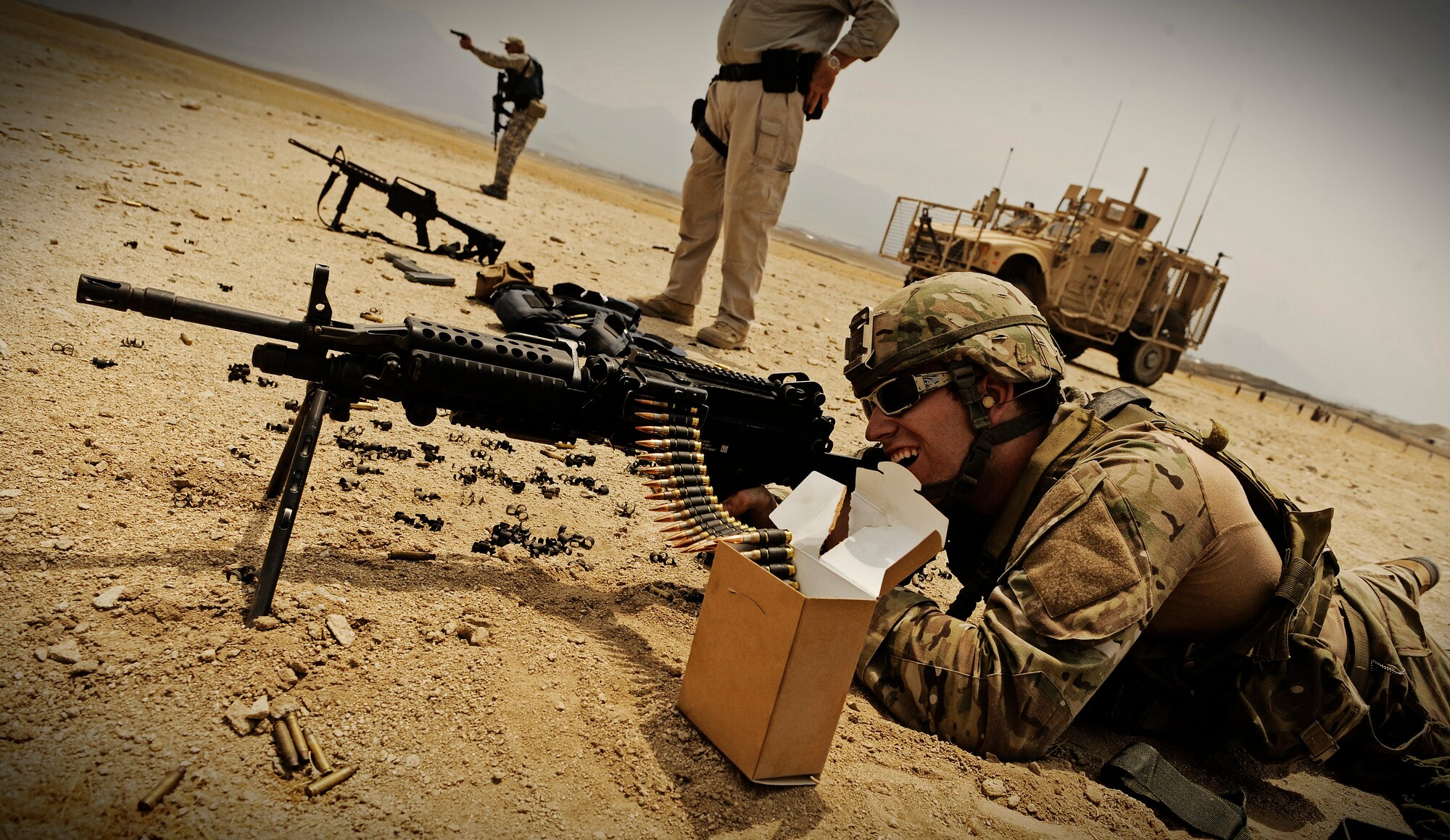 Staff Sgt. Ryan Crane, combat cameraman attached to Laghman Provincial Reconstruction Team, fires a Mk-48 machine gun during a qualification course at the Black Hills firing range in Laghman Province Sept. 3, 2011. Members from the PRT take turns practicing with multiple weapons systems to ensure they are proficient. (U.S. Air Force photo/ Capt. Tony Vincelli)