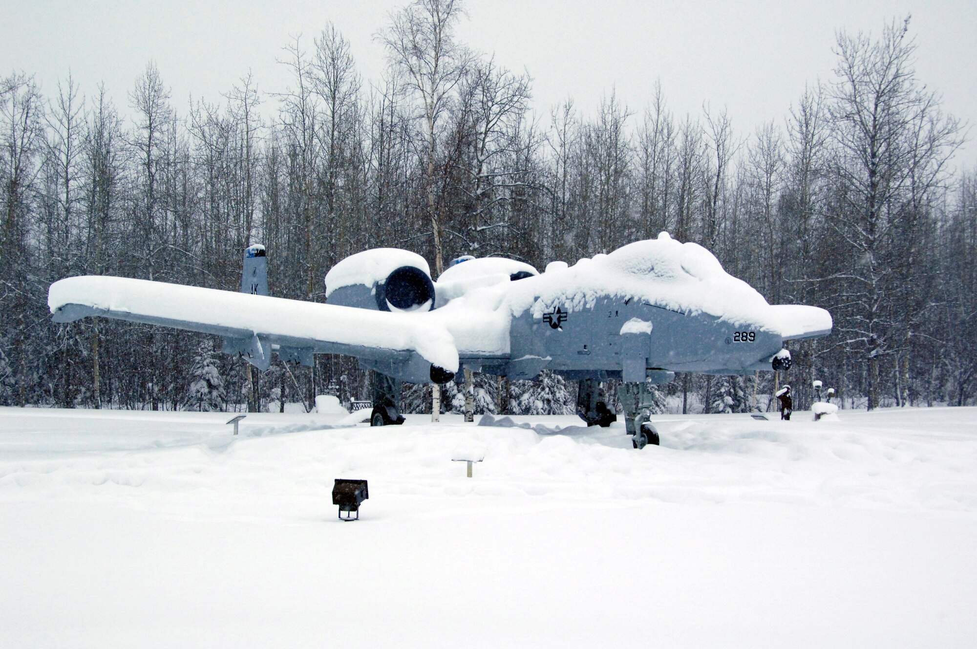 An A-10 Warthog static display was placed back to its original position at Heritage Park, Eielson Air Force Base, Alaska, March 6, 2012, after tipping backwards due to heavy snow accumulation in the area. A joint effort by members of the 354th Civil Engineer Squadron and 354th Maintenance Squadron helped restore the A-10 to its upright position after a passerby reported the aircraft was overtaken by heavy snow. While working, the 354th CES and 354th MXS crews discovered a locking pin used to secure the plane in place was missing. Efforts are now underway to ensure aircraft stability. (U.S. Air Force photo/Master Sgt. Jason Vaught)  