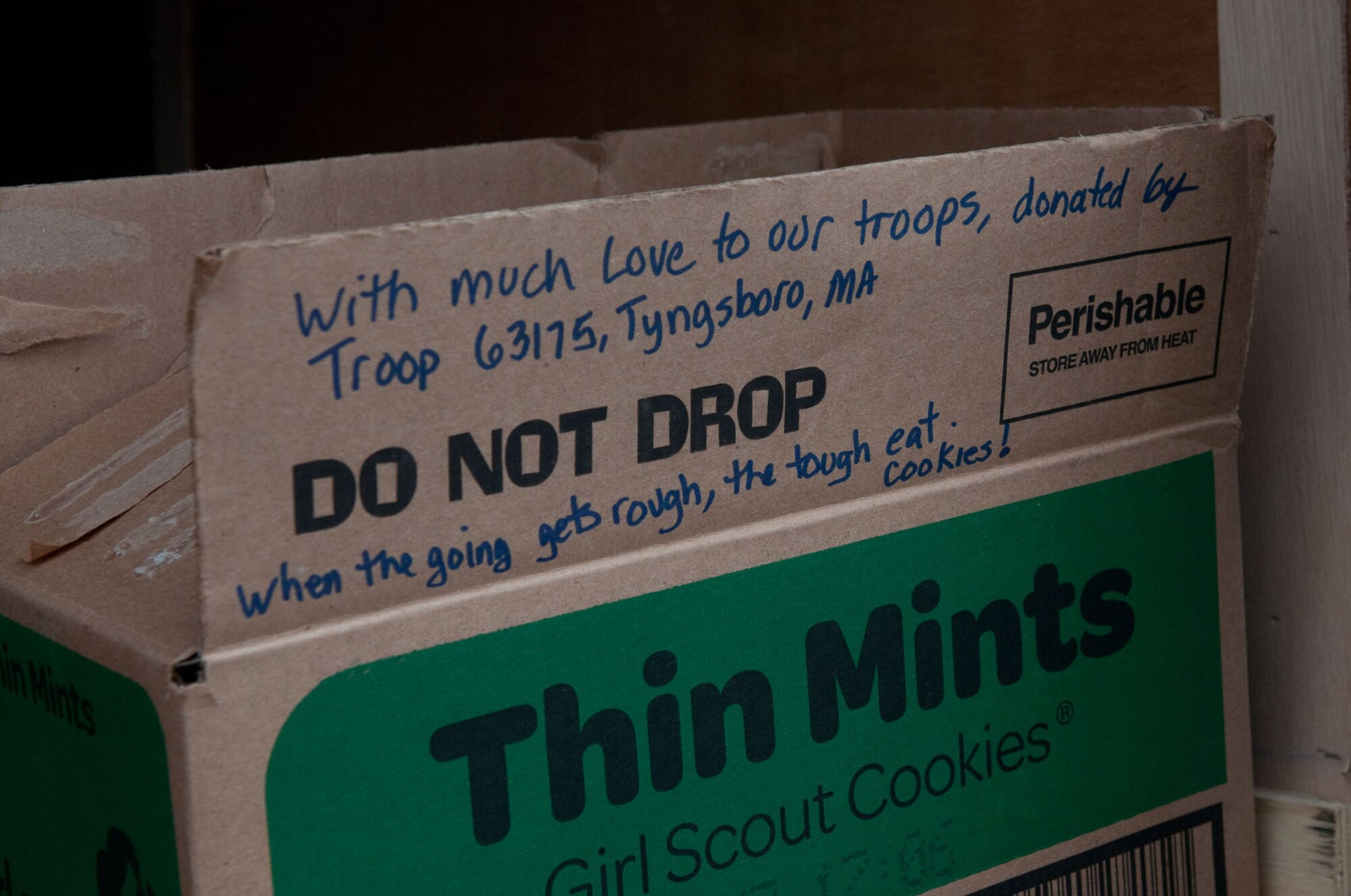 HANSCOM AIR FORCE BASE, Mass. – Some Girl Scout troops included messages with their donated cookies as part of Operation Cookie Drop March 3. Girl Scouts of Eastern Massachusetts began their annual Girl Scout cookie sale on Dec. 9, 2011, and sold cookies to be donated to troops overseas as part of their Cookies for a Cause program. (U.S. Air Force photo by Walter Santos)