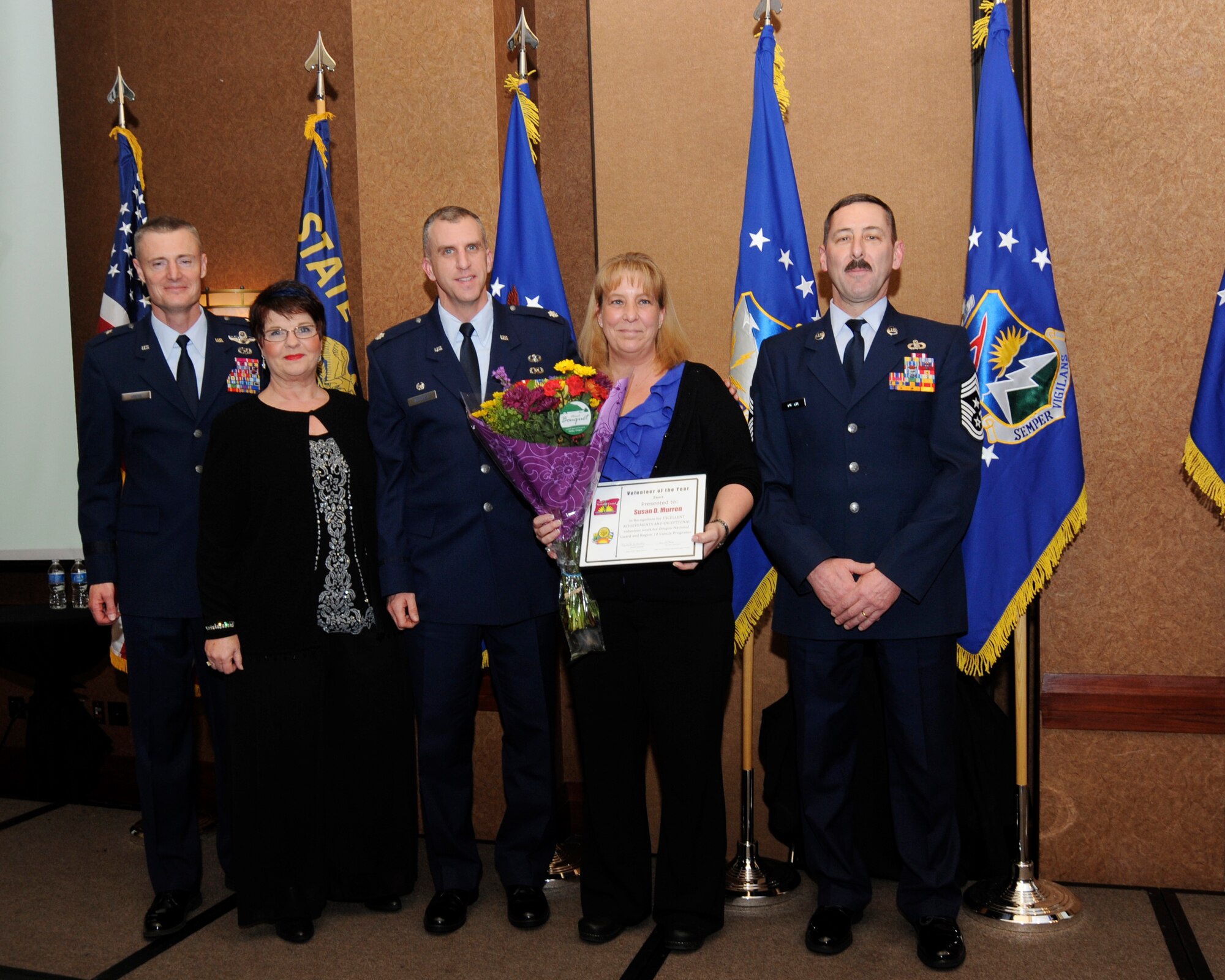 Ms. Susan Murren is presented with the Oregon Family Volunteer Award from (left to right) Oregon Air National Guard Commander Brig. Gen. Stephen Gregg, 142nd Family Program director Mary Bell, Lt. Col. Mitchell, Murren and State Command Chief Master Sgt. Mark Russell. (US Air Force Photo by Tech. John Hughel, 142nd Fighter Wing Public Affairs)