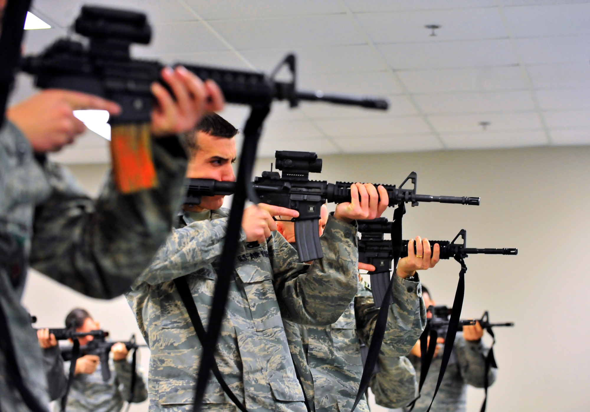 Airmen practice shoulder technique with their M4A2 assault rifles on Shaw Air Force Base, S.C. Feb. 27, 2012. There is an average of 14 to 18 individuals per class and three to five classes a week. The combat arms maintenance and training course lasts from 8 a.m. to 5:30 p.m. and trains between 3,000 – 4,500 Airmen per year. (U.S. Air Force photo by Senior Airman Neil D. Warner/Released)
