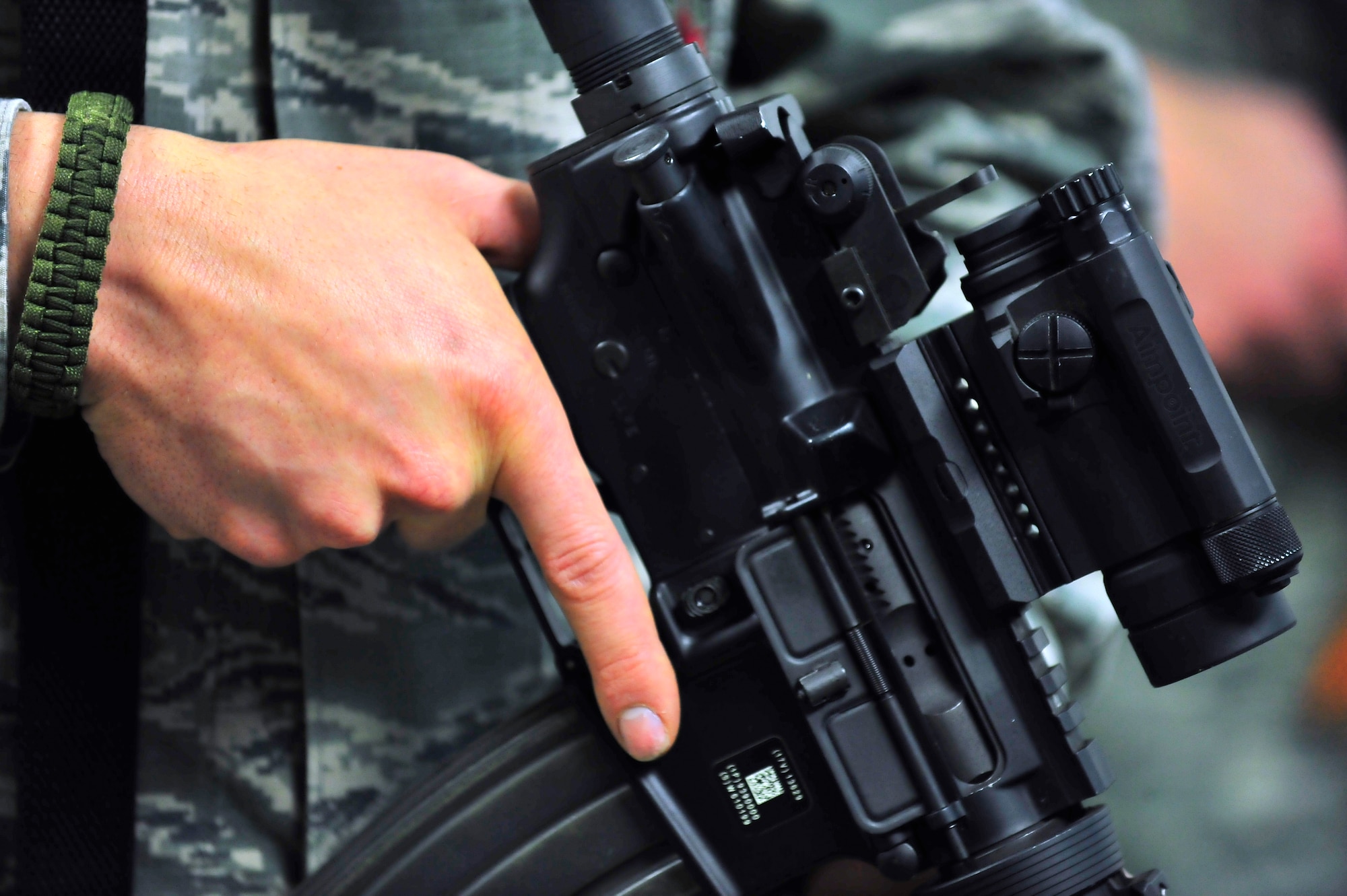 An Airman properly demonstrates finger placement while holding the M4A2 assault rifle at the low ready position on Shaw Air Force Base, S.C. Feb. 27, 2012. Airmen attending the combat arms maintenance and training course learn how to properly disassemble, clean and use proper shooting techniques. (U.S. Air Force photo by Senior Airman Neil D. Warner/Released)