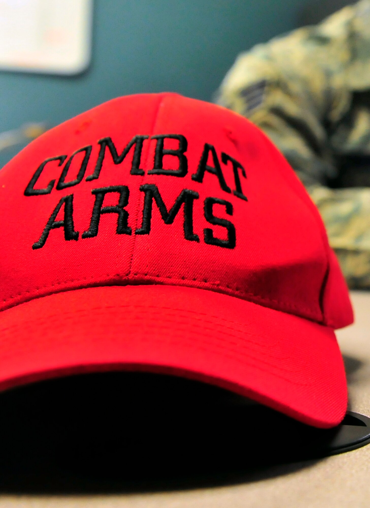 A combat arms maintenance and training instructor hat is displayed on a desk at Shaw Air Force Base, S.C. Feb. 27, 2012. The red CATM hat signifies recognition of training personnel while at the firing range. (U.S. Air Force photo by Senior Airman Neil D. Warner/Released)
