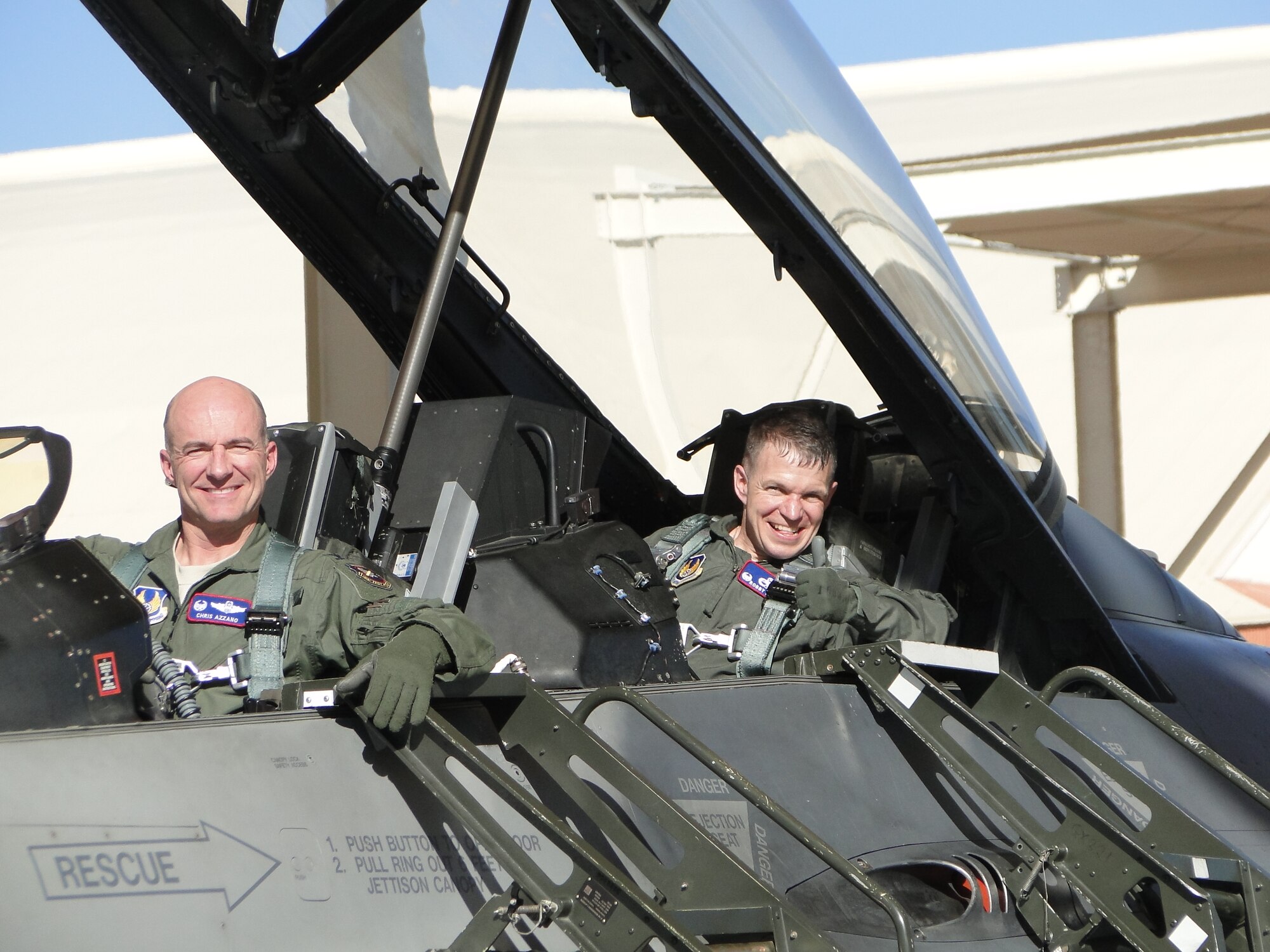 Col. Robert Weaver (right), 412th Maintenance Group commander, gives family members a thumbs up after taking part in an actual flight test mission in an F-16 with Col. Christopher Azzano, 412th Operations Group commander, on Jan. 13, 2012. This flight marked the first part in an initiative to give operators and maintainers the opportunity to create positive interaction so both gain insight into each other’s work dynamic. That initiative is called the 412th Operations and Maintenance Immersion Program. (U.S. Air Force courtesy photo)