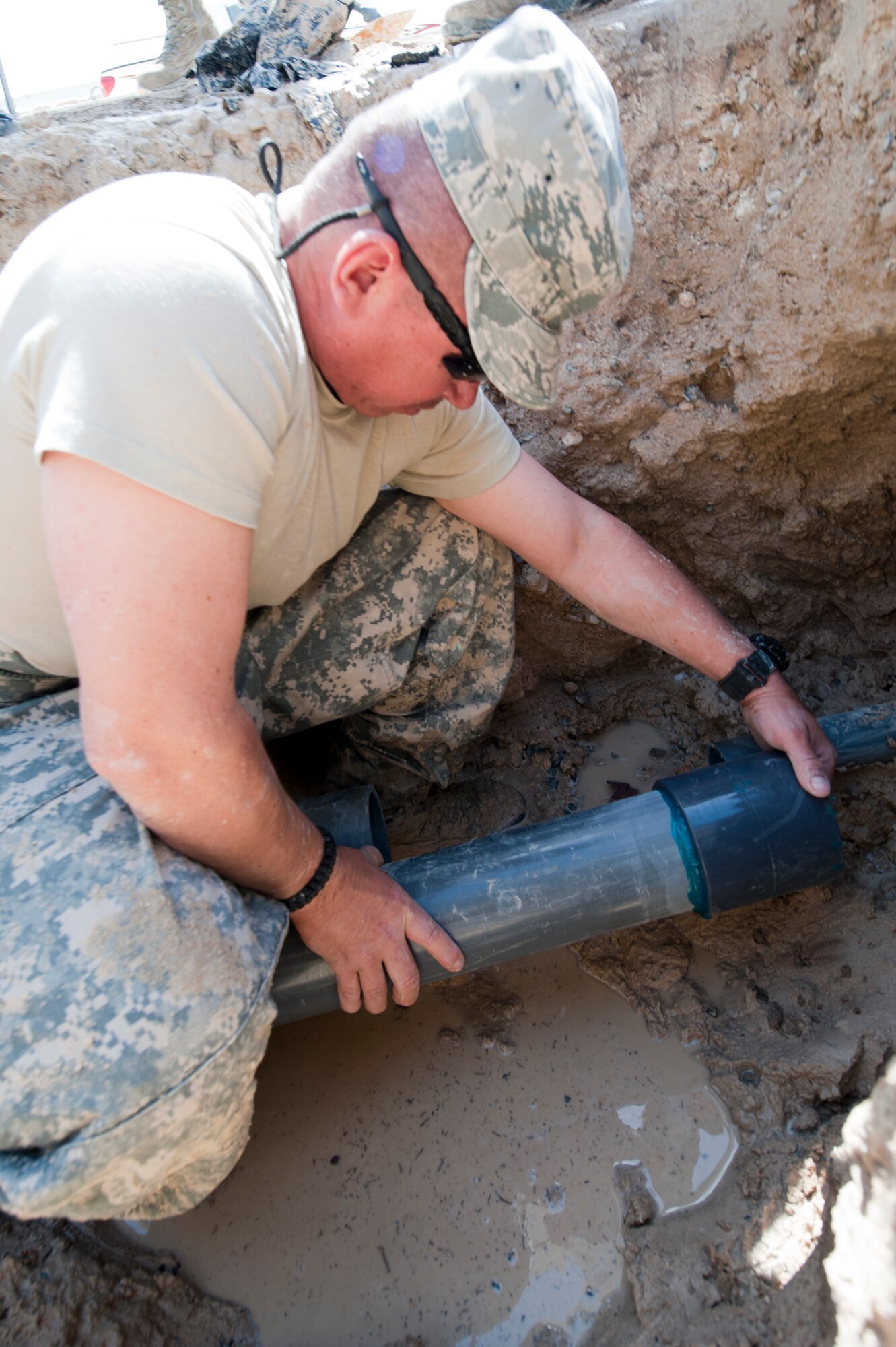 Staff Sgt. Antonio Martinez, 332nd Expeditionary Civil Engineer Squadron utilities shop member, measures the amount of polyvinyl chloride pipe needed to fix a waterline break at an undisclosed location in Southwest Asia, March 7, 2012. The 332nd ECES maintains all water and sewage lines on base. Martinez is deployed from Peterson Air Force Base, Colo., and is a Florida native. (U.S. Air Force photo by Staff Sgt. Joshua J. Garcia/Released)