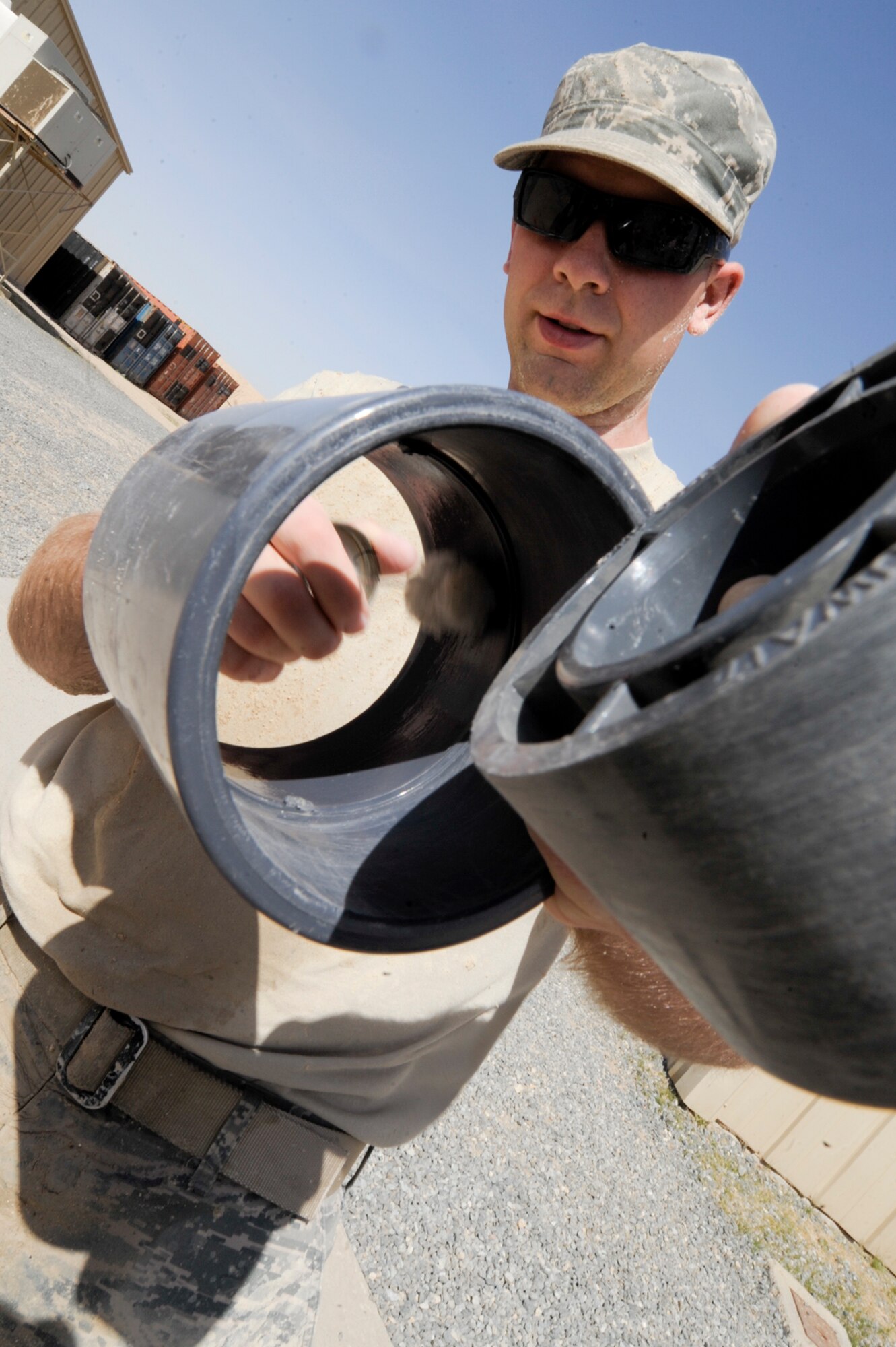 Senior Airman Kevin Stoner, 332nd Expeditionary Civil Engineer Squadron utilities shop member, applies cleaner to a polyvinyl chloride (PVC) pipe at an undisclosed location in Southwest Asia, March 7, 2012. Cleaning PVC pipes removes debris that can cause leaks. Stoner is deployed from Nellis Air Force Base, Nev., and is a native of Jacksonville, Fla. (U.S. Air Force photo by Staff Sgt. Joshua J. Garcia/Released)