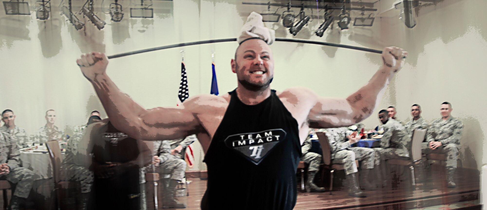 Professional strong man competitor Josh Thigpen folds a metal bar over his head like it was a coat-hanger. Thank goodness he and his commrades from Team Impact are on God's team (U.S. Air Force Photo by Capt. J. Justin Pearce).