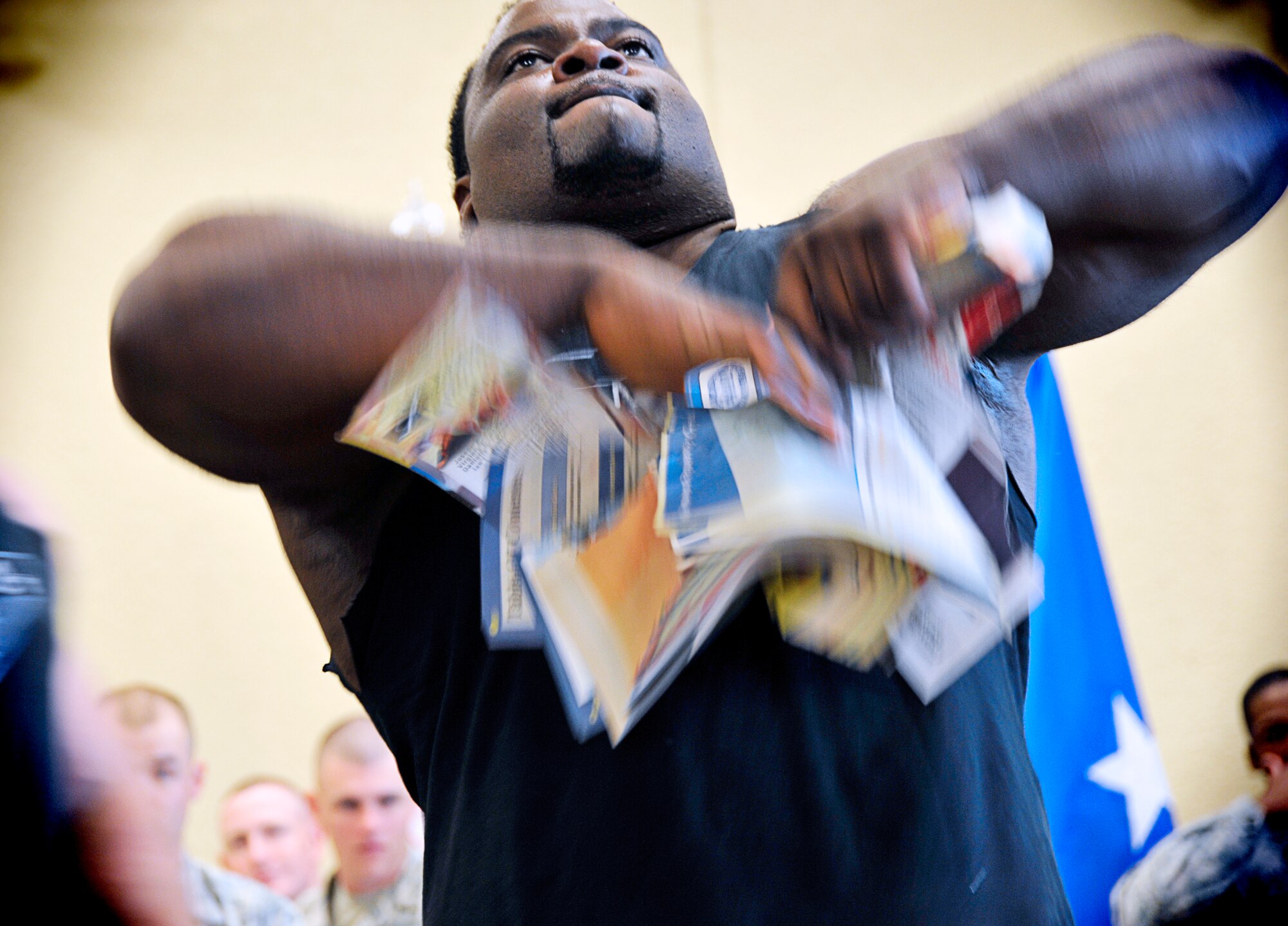 Mr. Randall Harris rips a phone book in half using only the grip of his hands. This is one of the many feats of strength Team Impact perform during their ministry events (U.S. Air Force Photo by Capt. J. Justin Pearce)