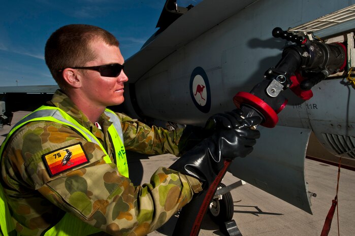 Royal Australian Air Force Leading Aircraftman Cameron Lawry, No. 75 Squadron crew chief, refuels an F/A-18 Hornet before a training mission during Red Flag 12-3, March 5, 2012 at Nellis Air Force Base, Nev. Red Flag is a realistic air-to-air combat training exercise involving the air forces of the United States and its allies. (U.S. Air Force photo by Senior Airman Brett Clashman)
