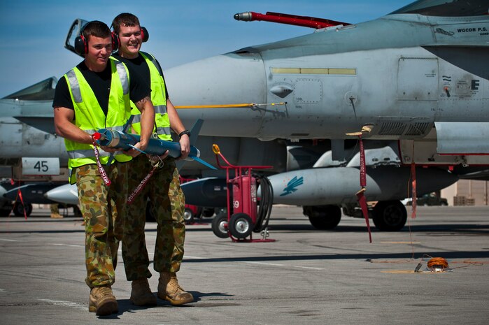 Royal Australian Air Force Leading Aircraftman Adam Buying (left) and LAC Daniel Skinner, No. 75 Squadron weapons specialists, transport a laser-guided practice rocket during Red flag 12-3, March 5, 2012 at Nellis Air Force Base, Nev. Red Flag is a realistic air-to-air combat training exercise involving the air forces of the United States and its allies. (U.S. Air Force photo by Senior Airman Brett Clashman)