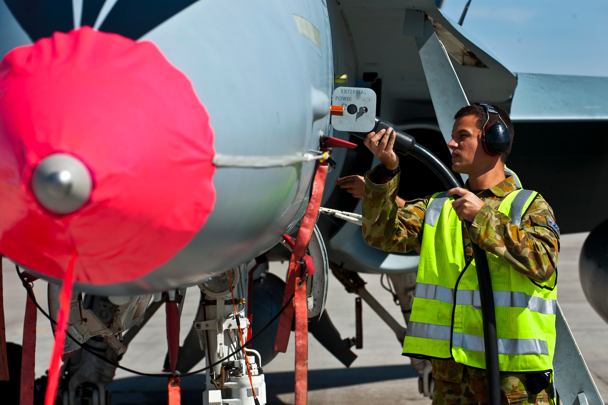 Royal Australian Air Force Leading Aircraftman Richard Taylor, No. 75 Squadron avionics specialist, charges the electrical power supply system of an F/A-18 Hornet during Red Flag 12-3, March 5, 2012 at Nellis Air Force Base, Nev. Red Flag is a realistic air-to-air combat training exercise involving the air forces of the United States and its allies. (U.S. Air Force photo by Senior Airman Brett Clashman)
