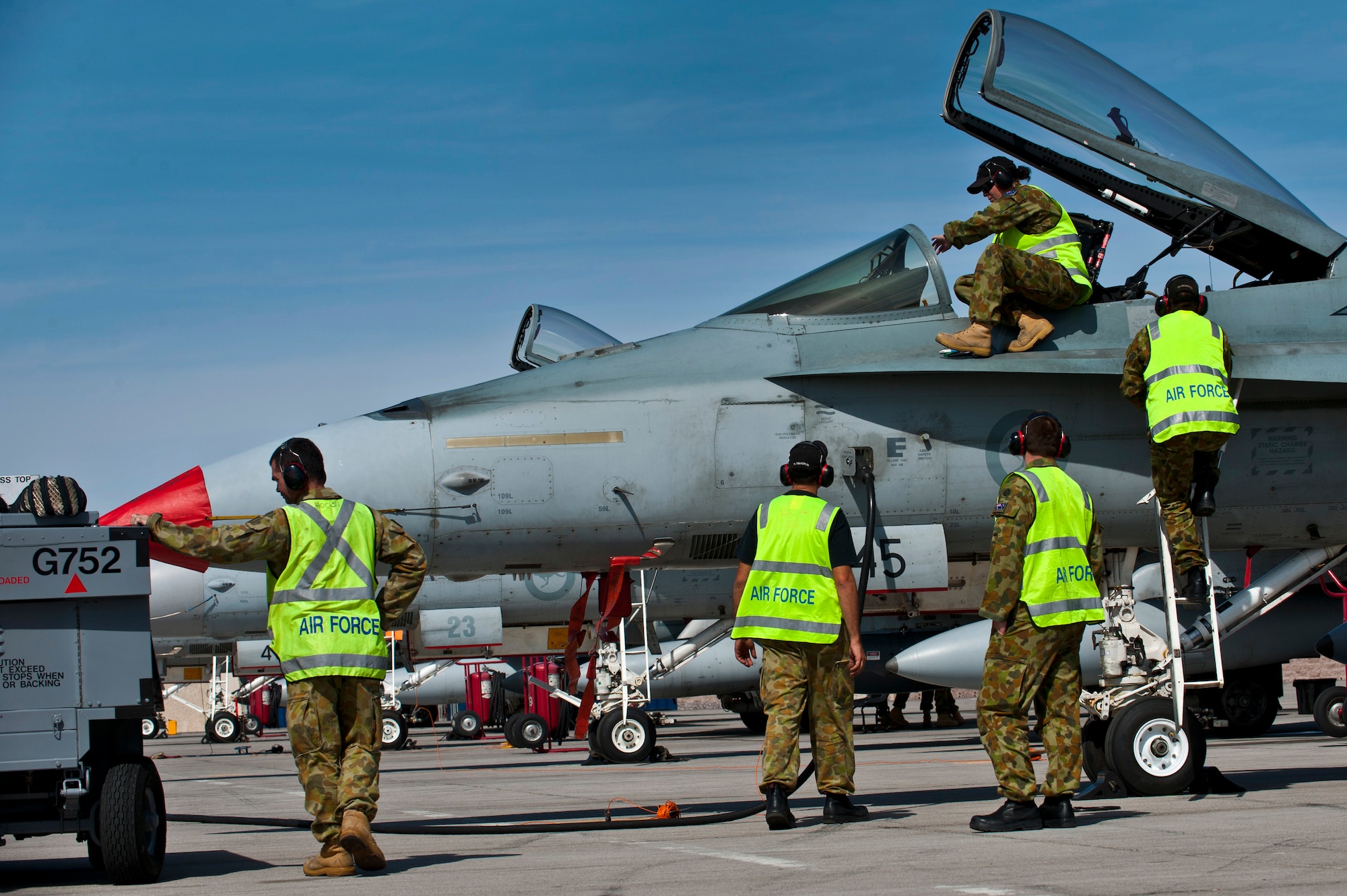Royal Australian Air Force Airmen from No. 75 Squadron perform pre-flight checks on an F/A-18 Hornet before a training mission during Red Flag 12-3, March 5, 2012 at Nellis Air Force Base, Nev. Red Flag is a realistic air-to-air combat training exercise involving the air forces of the United States and its allies. (U.S. Air Force photo by Senior Airman Brett Clashman)
