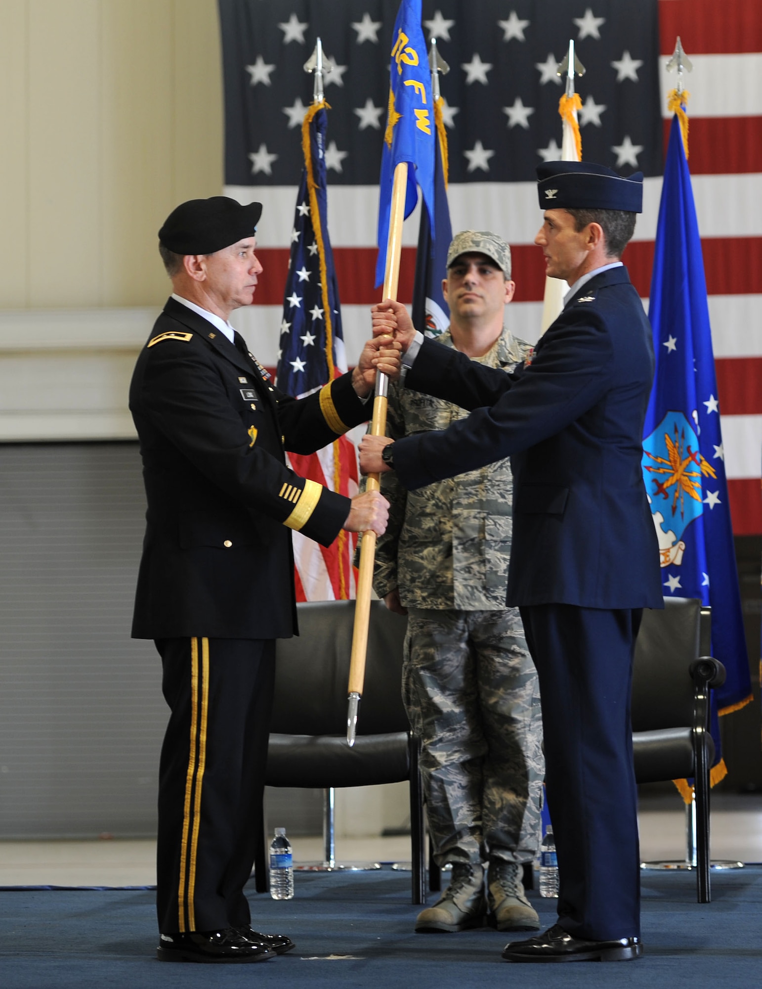 U.S. Army Maj. Gen. Daniel E. Long Jr., Adjutant General of Virginia, passes the guidon to U.S. Air Force Col. Thomas Wark, 192nd Fighter Wing commander, during a change of command ceremony at Langley Air Force Base, Va., March 4, 2012. Wark came to Langley from the National Guard Bureau, where he was the director of Air, Space and Information Operations. (U.S. Air Force photo by Airman 1st Class Teresa Cleveland/Released)