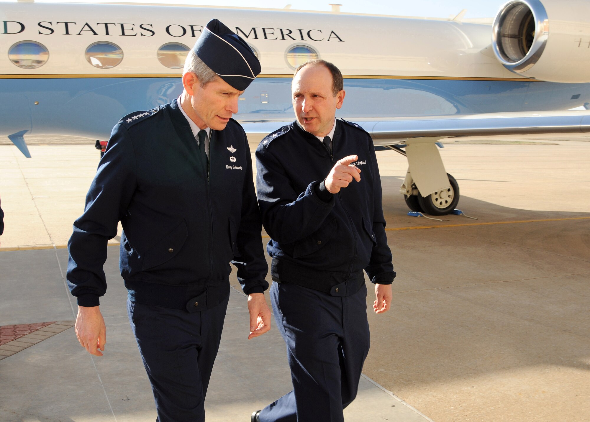 Air Force Chief of Staff Gen. Norton Schwartz speaks with Maj. Gen. Bruce Litchfield, Oklahoma City Air Logistics Center commander, after arriving at Tinker Air Force Base, Okla., March 5, 2012.  As part of his visit, General Schwartz gave a speech at the State of the Aerospace Defense Industry Luncheon in Oklahoma City.  (U.S. Air Force photo/David Faytinger)
