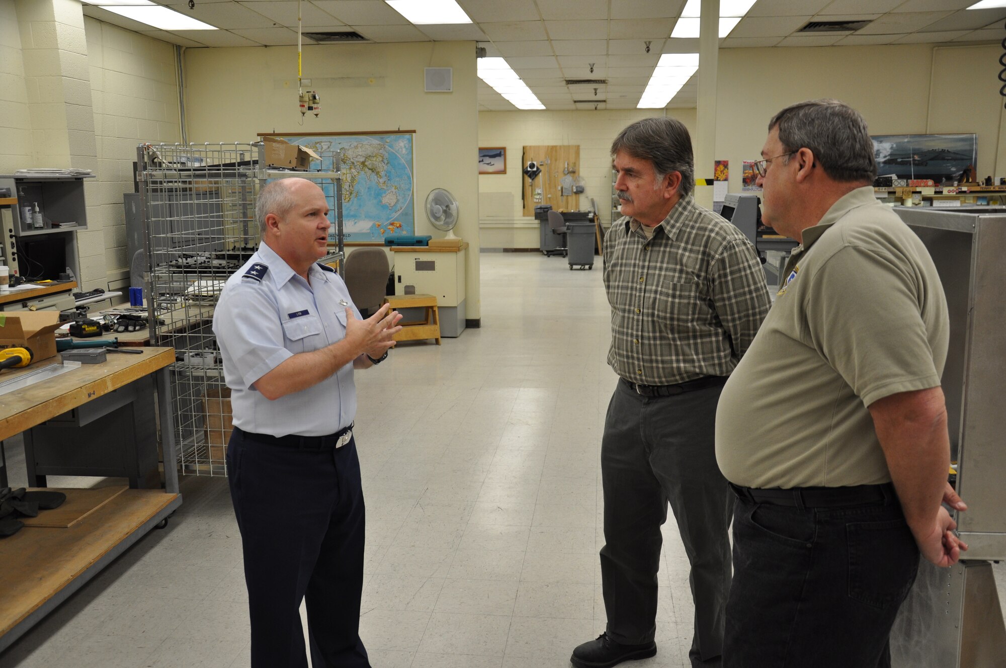 Maj. Gen. Charles Lyon, Air Combat Command director of operations, visits with Detachment 1 model makers Terry Waugh and Floyd Slinker, who designed a critical modification to the F-22 Raptor’s Emergency Oxygen System handle. Lyon visited the detachment on March 5 to recognize them for their hard work and innovation.   (U.S. Air Force photo by Capt. Tristan Hinderliter)