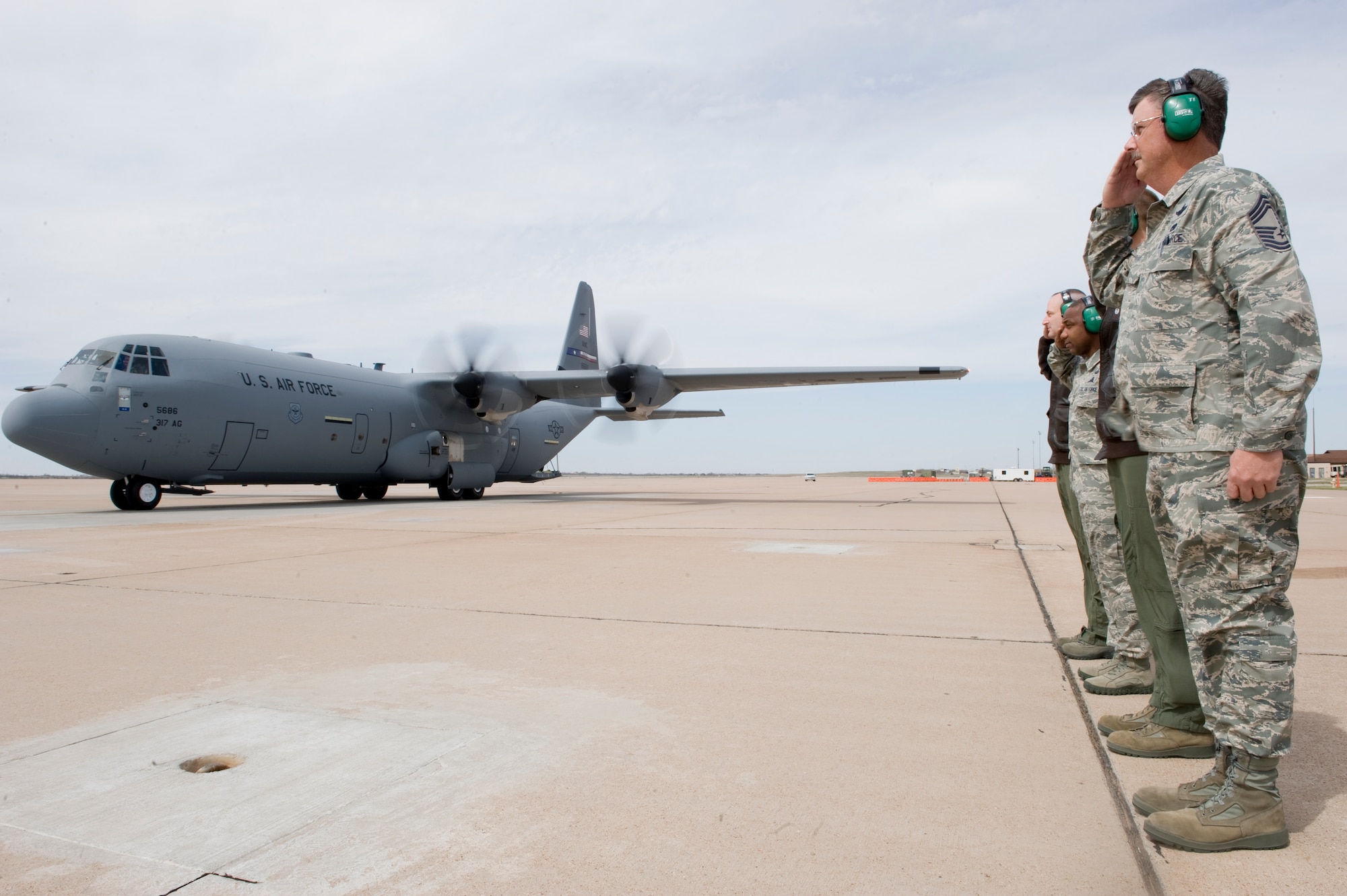 Members from the 7th Bomb Wing render a salute as Maj. Gen. Rowayne A. Schatz Jr., Air Mobility Command director of strategic plans, taxis in a new J-model March 6, 2012, at Dyess Air Force Base, Texas. The aircraft is 16th of 28 J-models to be delivered to Dyess by 2013, replacing the current legacy fleet of C-130 H-models. (U.S. Air Force photo by Airman 1st Class Jonathan Stefanko/Released)