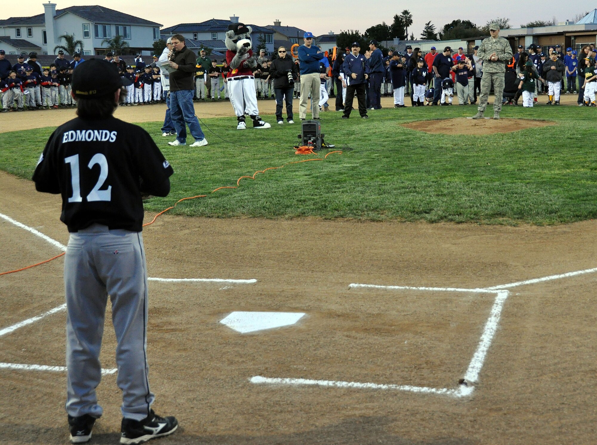 Andrew Edmonds, #12 on the Vacaville National Little League Major
Pirates team, awaits for Staff Sgt. David Adkins, 60th Civil Engineer
Squadron munitions NCO in charge, to launch the first pitch of the season
March 2 in Arlington Park. (U.S. Air Force photo/Airman 1st Class Madelyn
Ottem)
