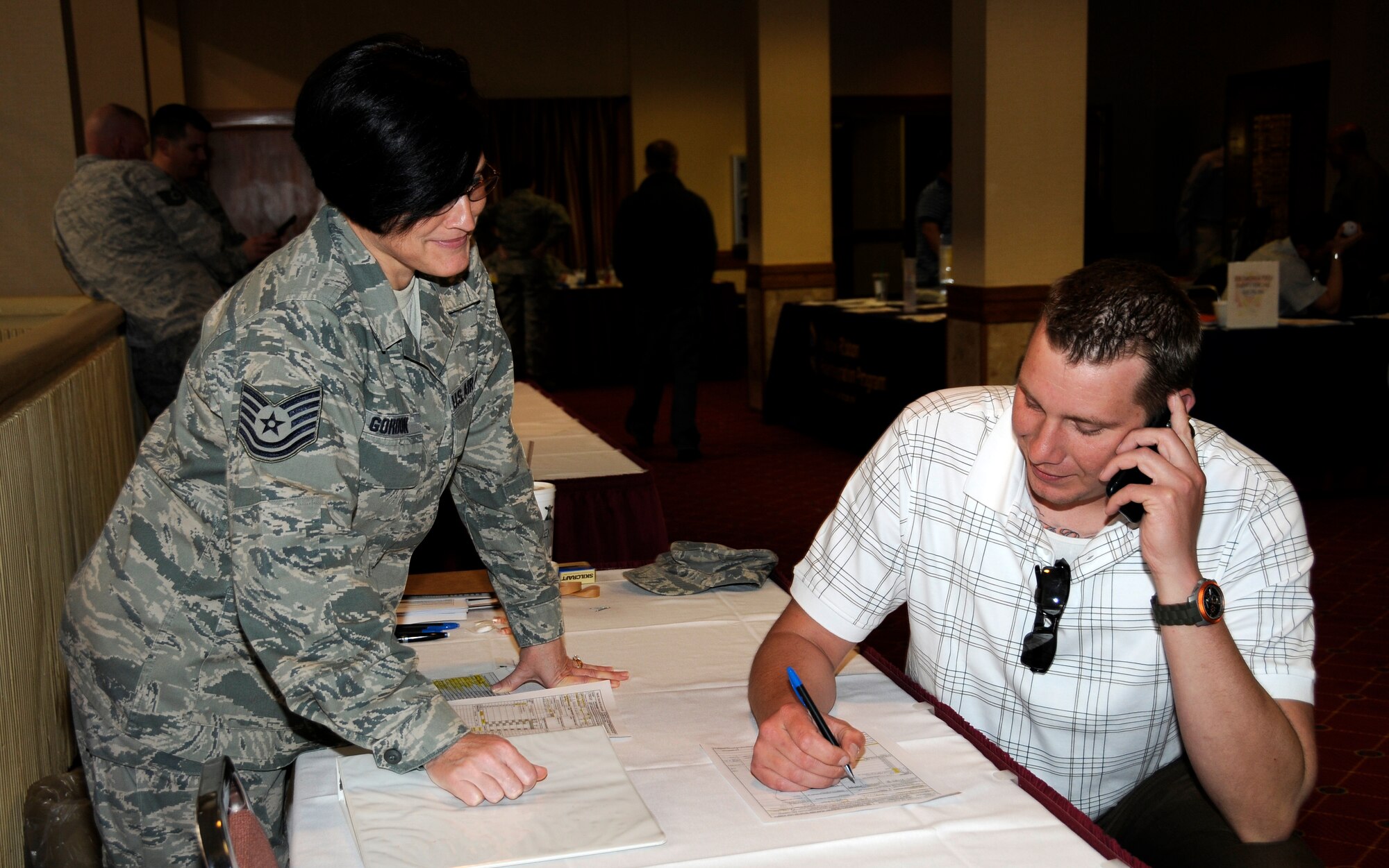 Tech Sgt. Minnie Gordon with the 188th Finance Management Flight, left, helps a service member complete a travel voucher during a Yellow Ribbon Reintegration Program predeployment event March 3, 2012, at the Holiday Inn Convention Center in Fort Smith, Ark. (National Guard photo by Airman 1st Class Hannah Landeros/188th Fighter Wing Public Affairs)