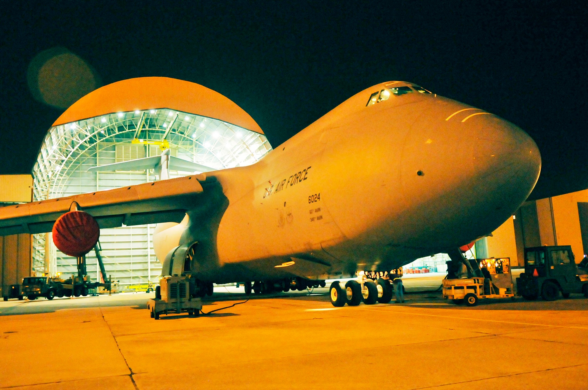 A C-5  from Travis AFB here for a horizontal stabilizer replacement, is readied by maintenance workers to be towed out of the hanger. (U. S. Air Force photo by Sue Sapp)