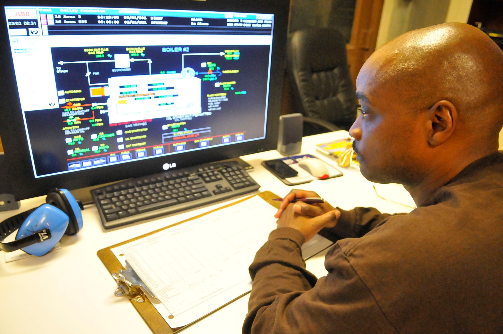 Ernest Moss, boiler plant operator, monitors boiler and steam output. (U. S. Air Force photo by Sue Sapp)