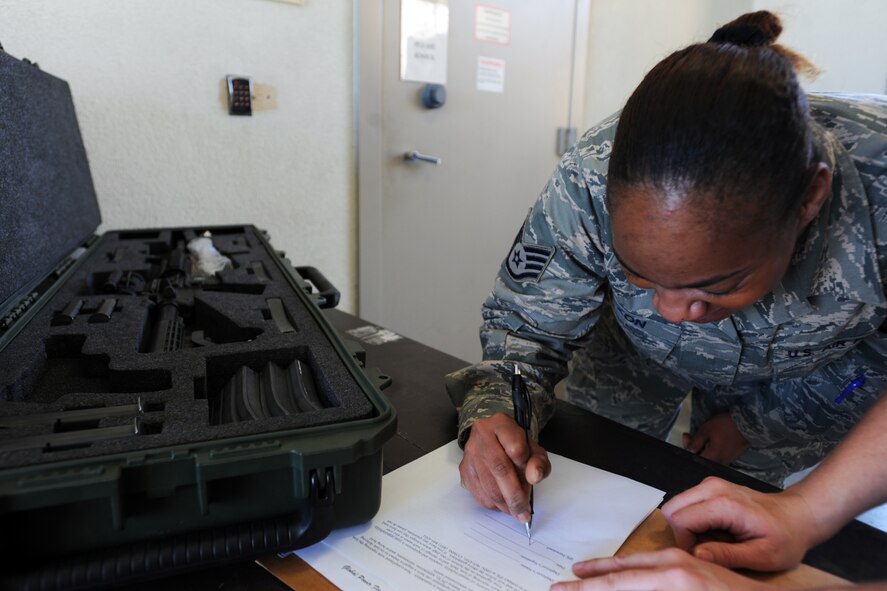 U.S. Air Force Staff Sgt. Toletha Dixon, 20th Logistics Readiness Squadron individual protection equipment NCO, signs out her weapon for the Sea Lion exercise at Shaw Air Force Base, S.C., March 6, 2012. An Operation Readiness Exercise prepares and gives Airmen the chance to experience how the processing line and operation works if they were to deploy. (U.S. Air Force photo by Senior Airman Tabatha McCarthy/released)