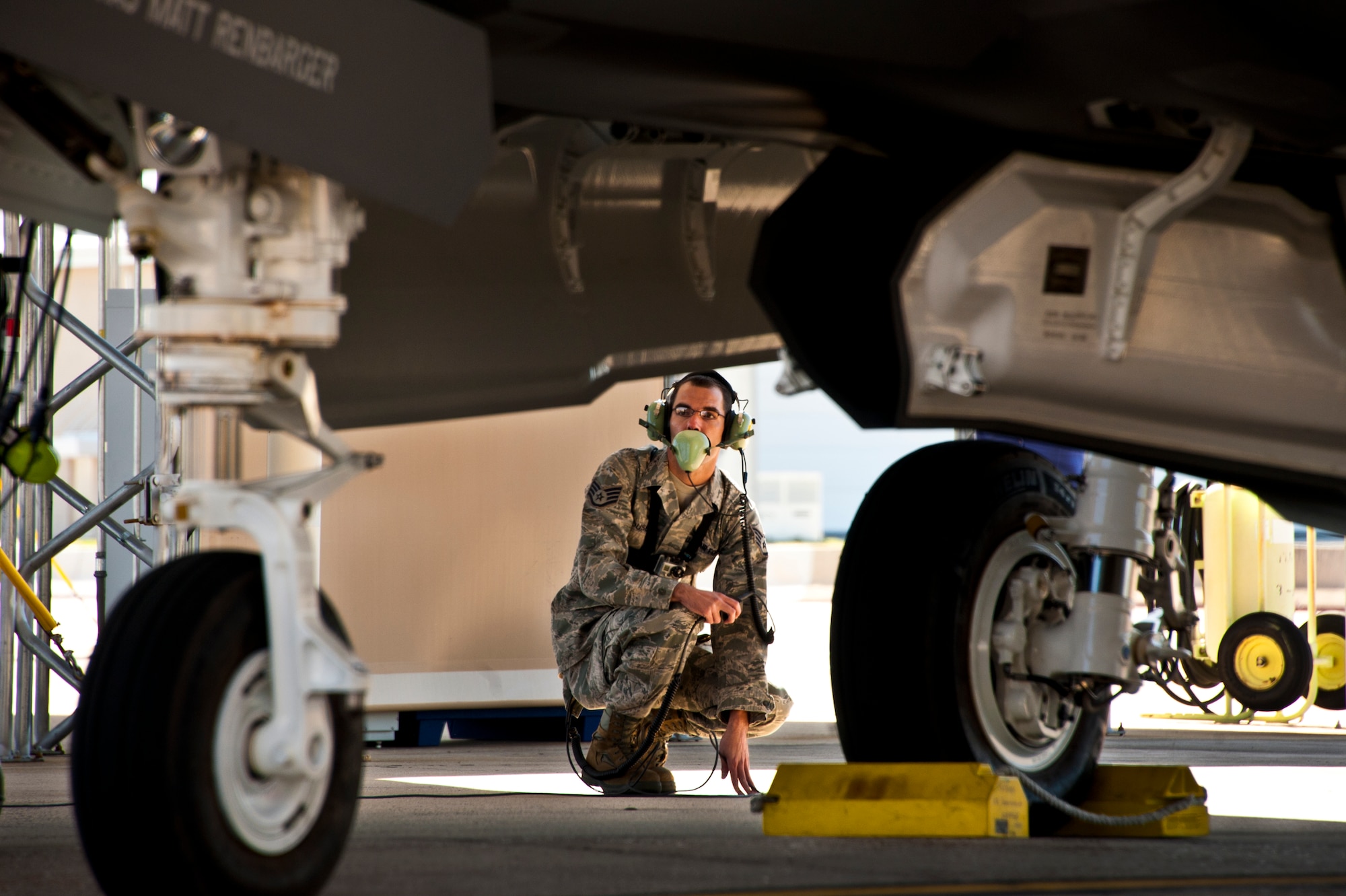 Staff Sgt. Jeremy Houser, a 33rd Aircraft Maintenance Squadron maintainer, communicates with the pilot of the F-35A Lightning II joint strike fighter during flight checks prior to the first-ever training sortie March 6 at Eglin Air Force Base, Fla.  Houser was the crew chief for the first sortie.  (U.S. Air Force photo/Samuel King Jr.)
