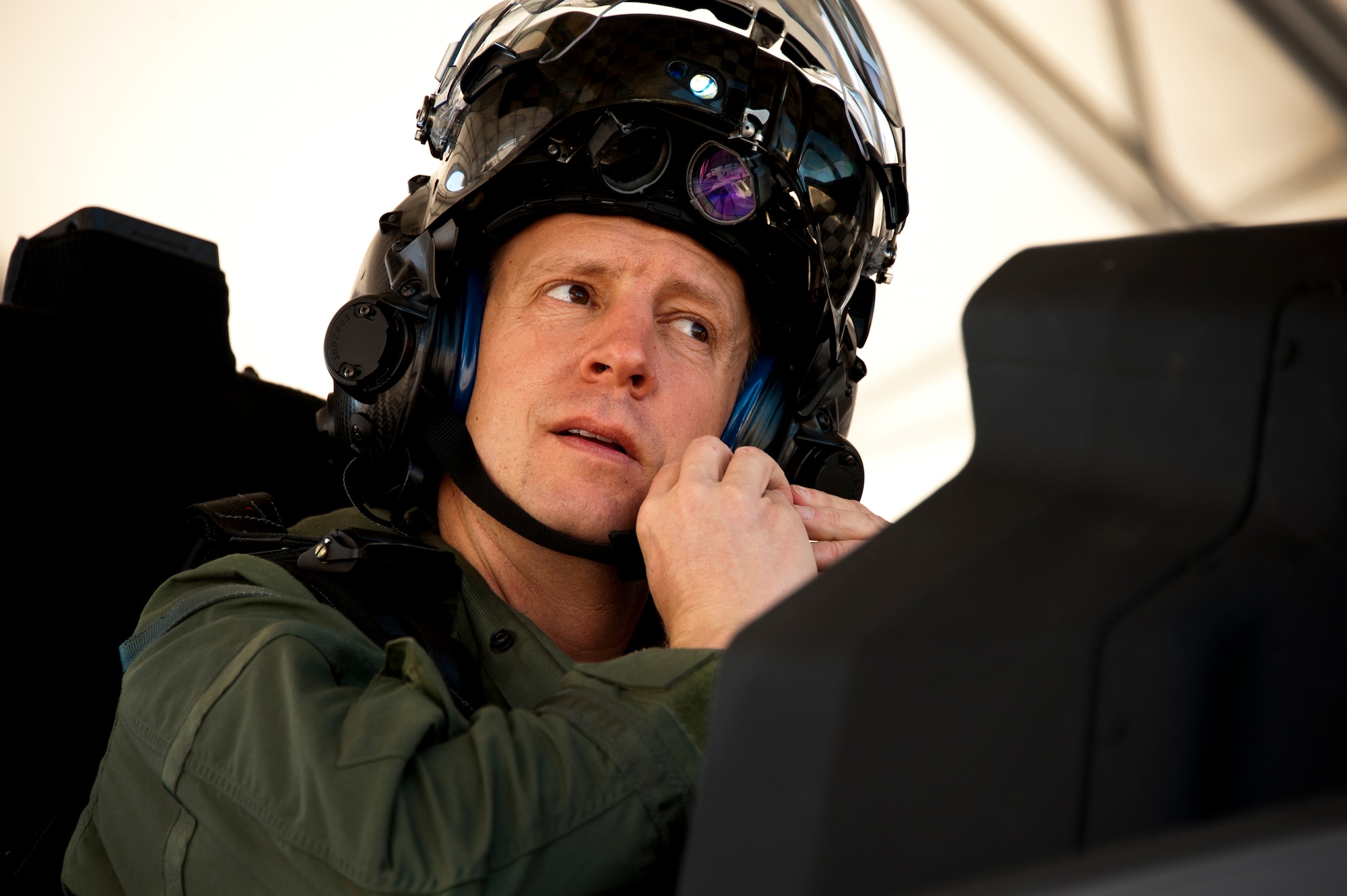 Lt. Col. Eric Smith, the 58th Fighter Squadron director of operations, secures his helmet from the cockpit of the F-35A Lightning II joint strike fighter prior to its first-ever training sortie March 6 at Eglin Air Force Base, Fla.  Smith is the first Air Force pilot qualified to fly the F-35.  (U.S. Air Force photo/Samuel King Jr.)