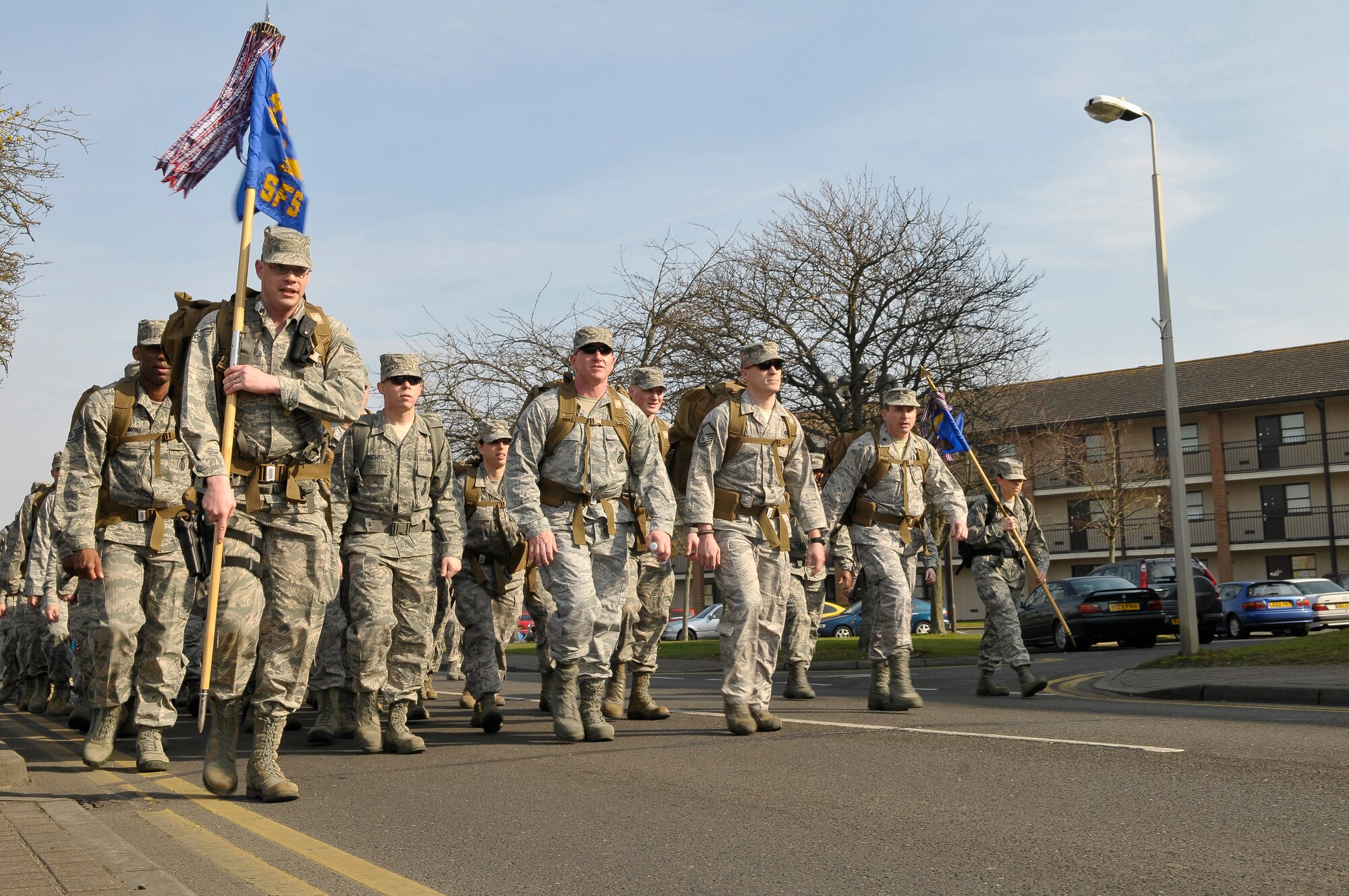 ROYAL AIR FORCE LAKENHEATH, England -- Members of the 48th Security Forces Squadron ruck march during the Liberty?s Fallen Defenders 5K Memorial Race fundraiser March 1, 2012.  The race was set a day before the one year anniversary of the shooting at Frankfurt International Airport, Germany where two 48th SFS Airmen were injured and Senior Airman Nicholas Alden lost his life.  To honor him and all Liberty Defenders killed in the line of duty since 2001, a monument was built at RAF Lakenheath.  (U.S. Air Force photo by Staff Sgt. Connor Estes)