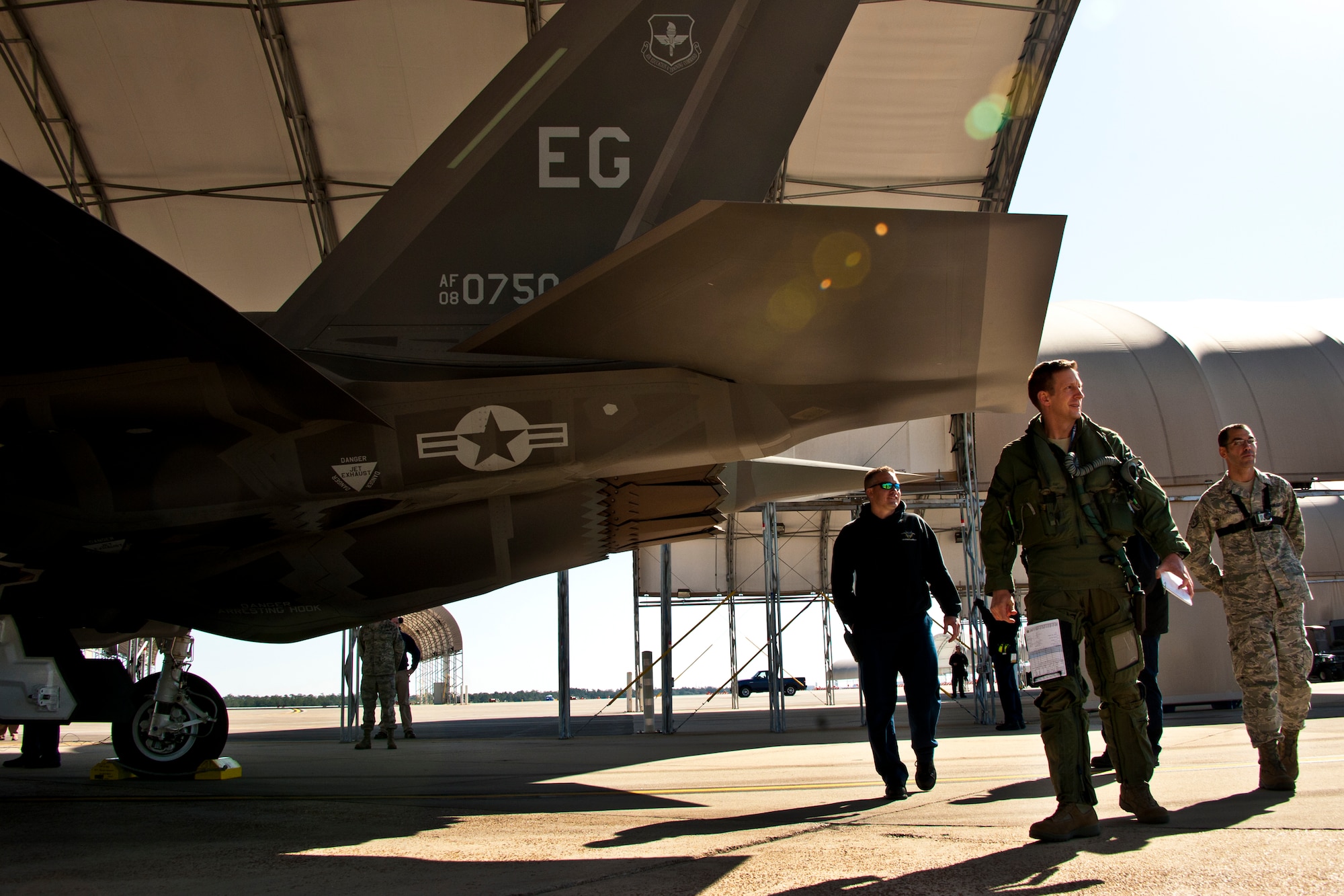 Lt. Col. Eric Smith, the 58th Fighter Squadron director of operations, walks around the F-35A Lightning II joint strike fighter prior to its first-ever training sortie March 6 at Eglin Air Force Base, Fla.  Smith is the first Air Force pilot qualified to fly the F-35.  (U.S. Air Force photo/Samuel King Jr.)