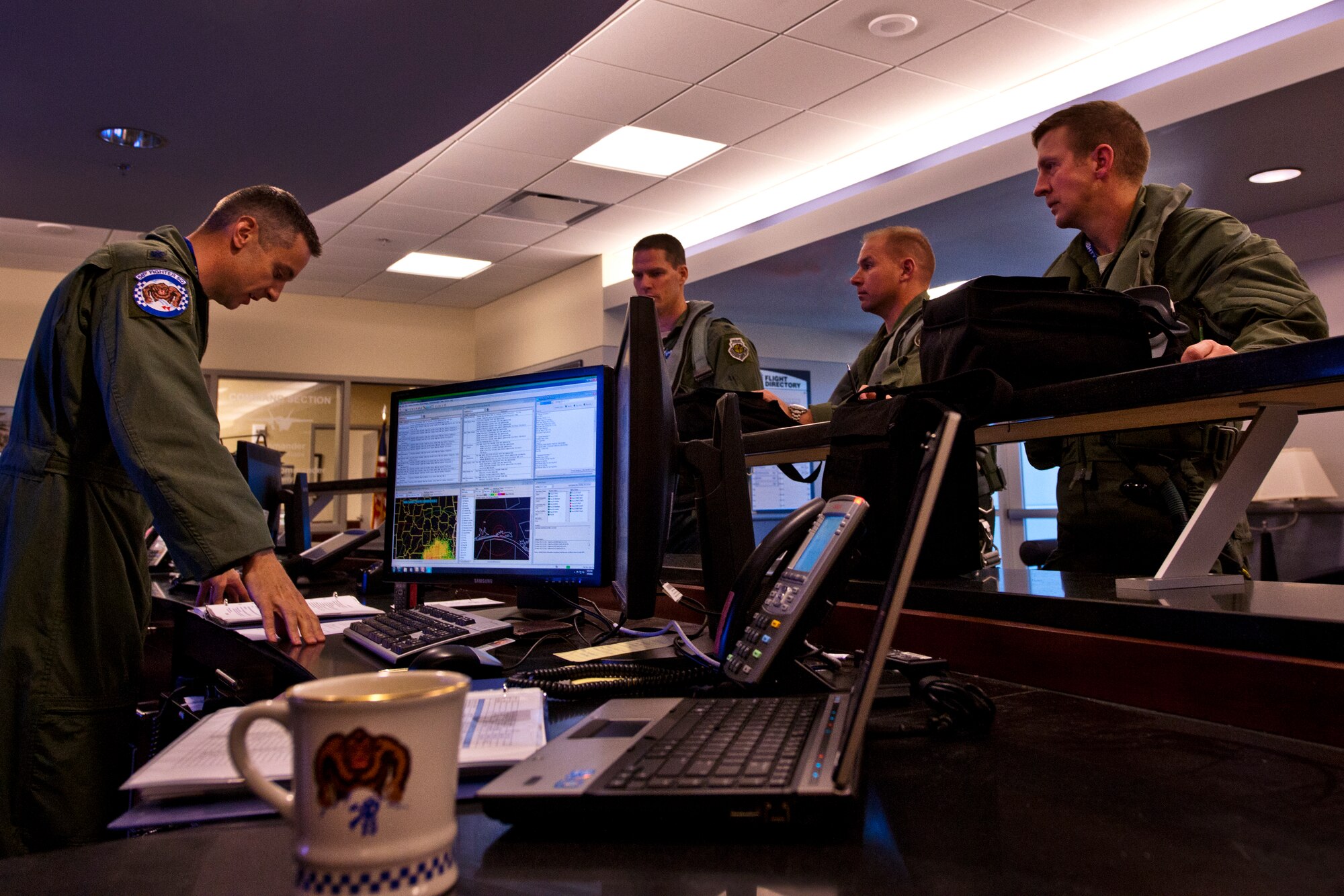 (Right to left) Lt. Col. Eric Smith, the first Air Force qualified F-35 pilot, Maj. Joseph Bachmann, the first Marine qualified F-35 pilot, and Lt. Col. Lee Kloos, the 58th Fighter Squadron commander, receive an operations brief from Lt. Col. Todd LaFortune before stepping out for the first-ever F-35A Lightning II joint strike fighter training sortie March 6 at Eglin Air Force Base, Fla.  (U.S. Air Force photo/Samuel King Jr.)