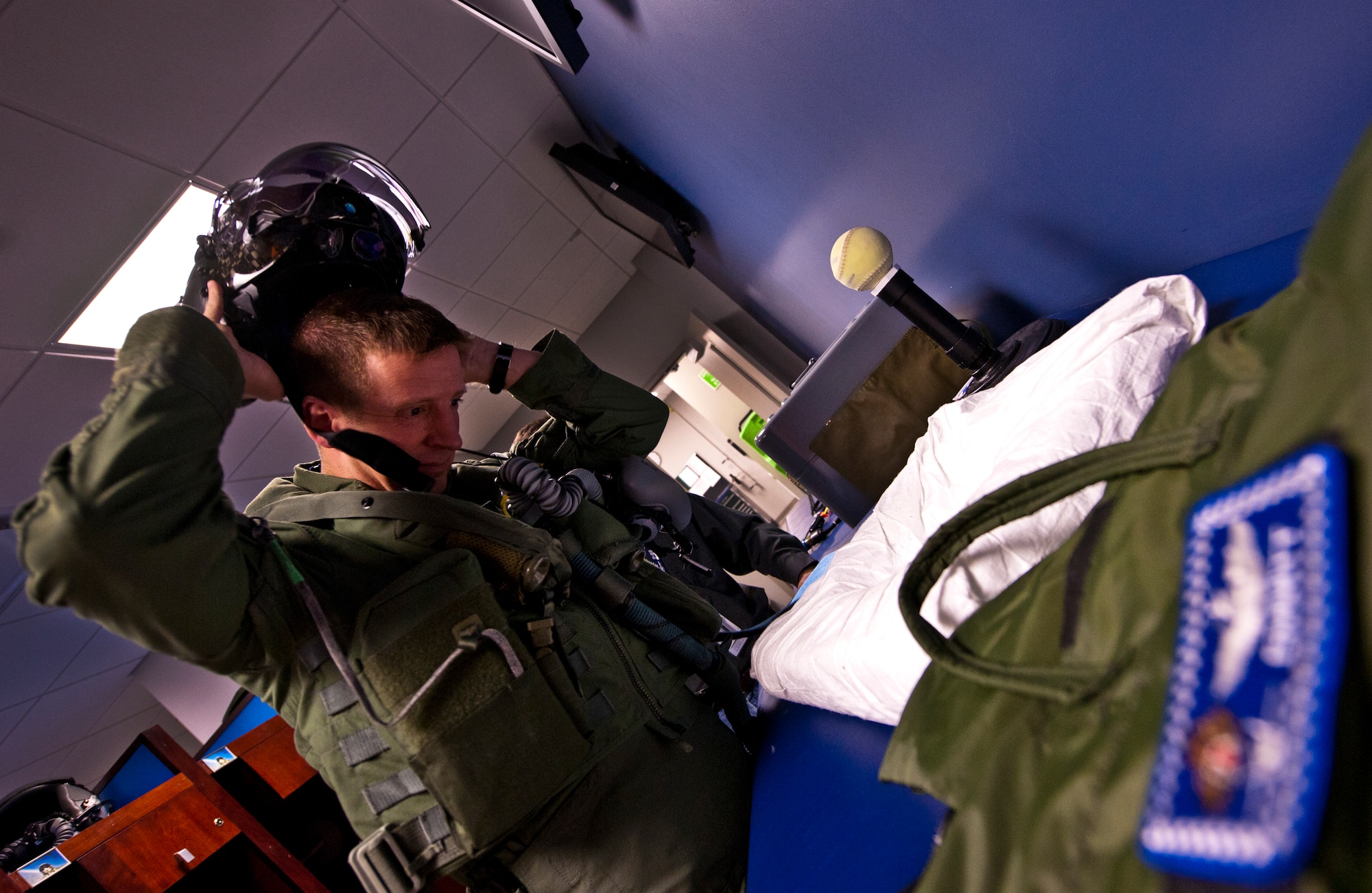 Lt. Col. Eric Smith, the 58th Fighter Squadron director of operations, removes his helmet after a successful test prior to stepping to the F-35A Lightning II joint strike fighter for its first-ever training sortie March 6 at Eglin Air Force Base, Fla.  Smith is the first Air Force pilot qualified to fly the F-35.  The helmet is tested with a computer before every sortie.  (U.S. Air Force photo/Samuel King Jr.)