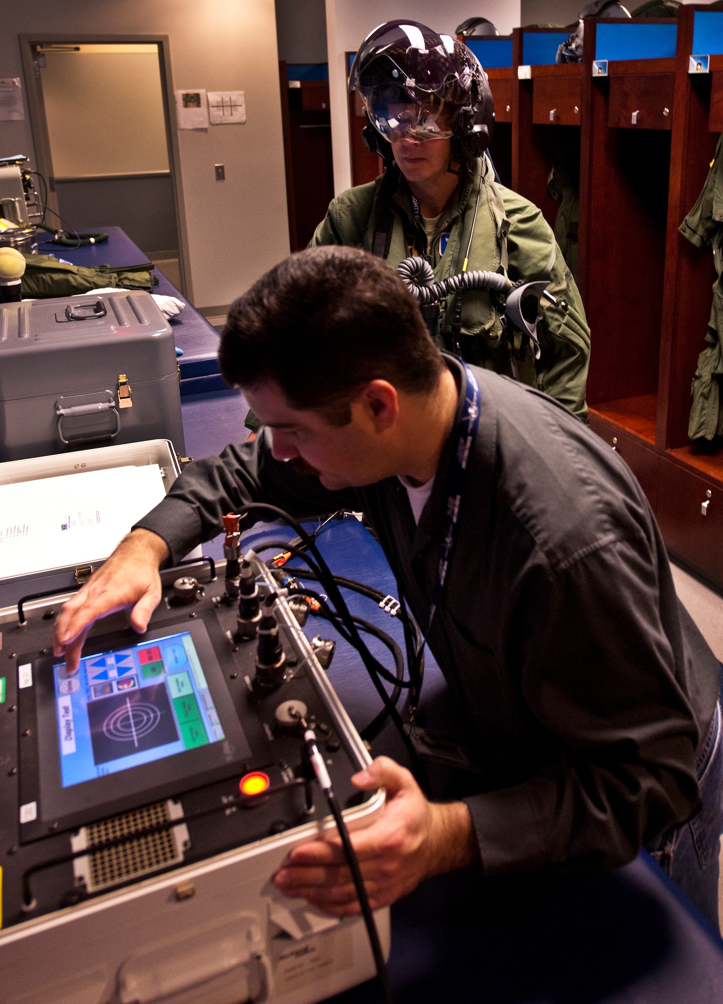 Lt. Col. Eric Smith, the 58th Fighter Squadron director of operations, undergoes a computerized helmet test prior to stepping to the F-35A Lightning II joint strike fighter for its first-ever training sortie March 6 at Eglin Air Force Base, Fla.  Smith is the first Air Force pilot qualified to fly the F-35.  The helmet is tested with a computer before each sortie.  (U.S. Air Force photo/Samuel King Jr.)