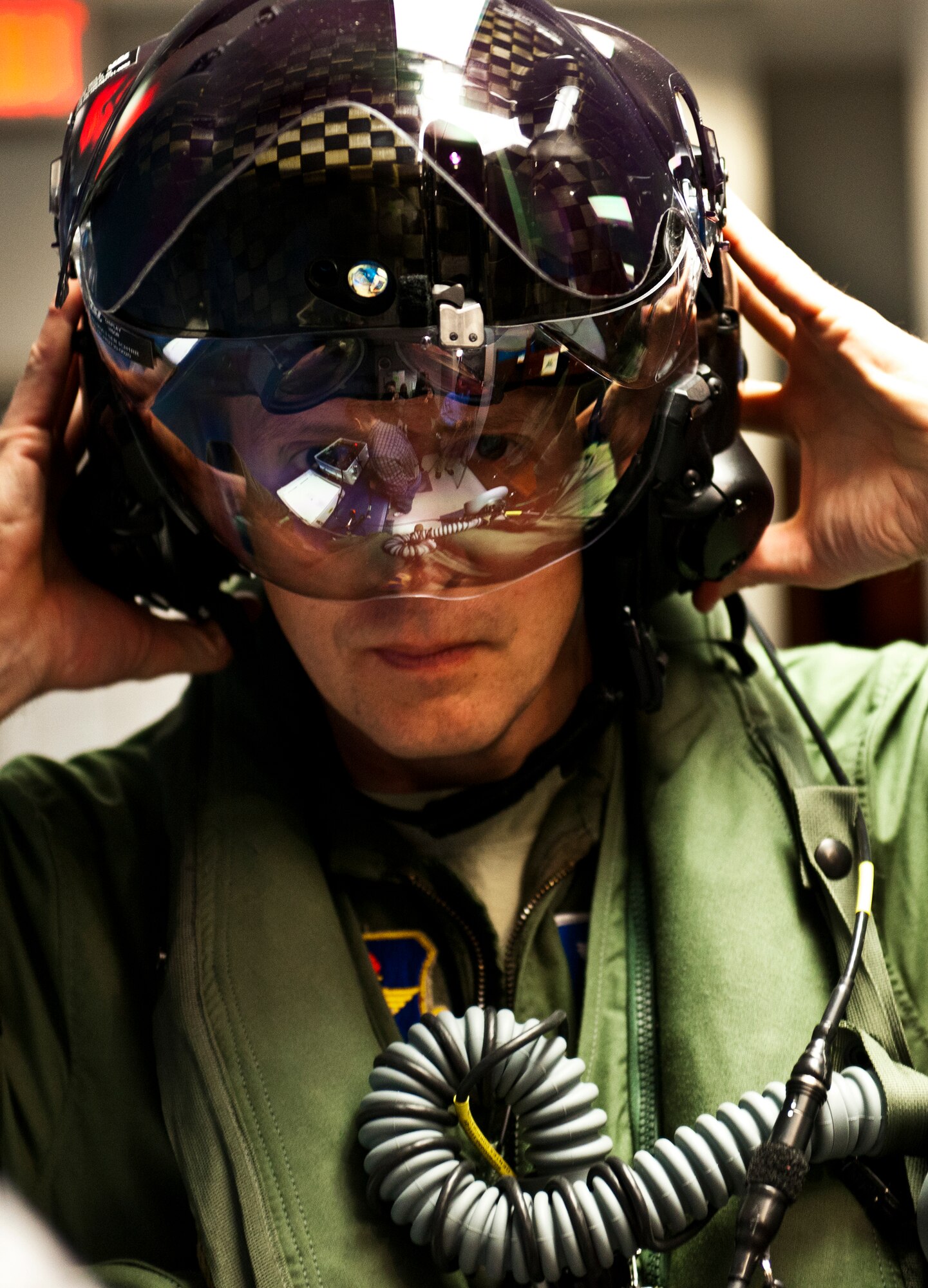 Lt. Col. Eric Smith, the 58th Fighter Squadron director of operations, secures his helmet for testing prior to stepping to the F-35A Lightning II joint strike fighter for its first-ever training sortie March 6 at Eglin Air Force Base, Fla.  Smith is the first Air Force pilot qualified to fly the F-35.  (U.S. Air Force photo/Samuel King Jr.)