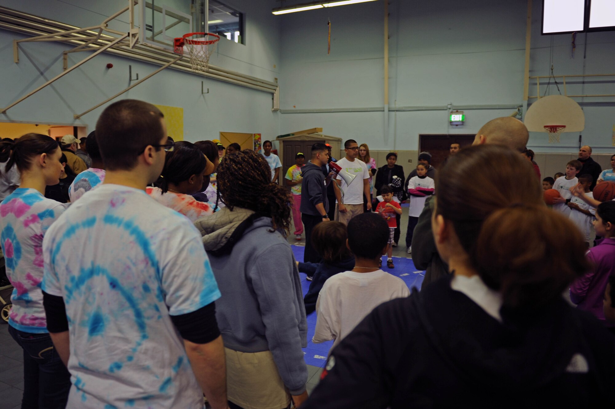 SPANGDAHLEM AIR BASE, Germany – Senior Airman Frank Balingit, 52nd Force Support Squadron fitness specialist, explains the activities that will take place during the FitFactor X-Games event at the Spangdahlem Middle School here March 3. FSS Youth Programs sponsored the event to introduce and familiarize students and their parents with Air Force fitness and health initiatives. FitFactor is an Air Force-wide youth fitness and health program that challenges children age 6 to 18 to be active for an hour each day, eat right and make healthy lifestyle choices. (U.S. Air Force photo by Airman 1st Class Matthew B. Fredericks/Released)