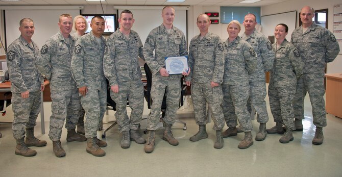 Staff Sgt. Adam Hills, 39th Civil Engineer Squadron, is presented the February 2012 Diamond Sharp Award by members of the Incirlik First Sergeant Council March 7, 2012, at Incirlik Air Base, Turkey. Hills earned the monthly award by distinguishing himself through outstanding professionalism, performance and display of the Air Force core values. (U.S. Air Force photo by Senior Airman Anthony Sanchelli/Released)