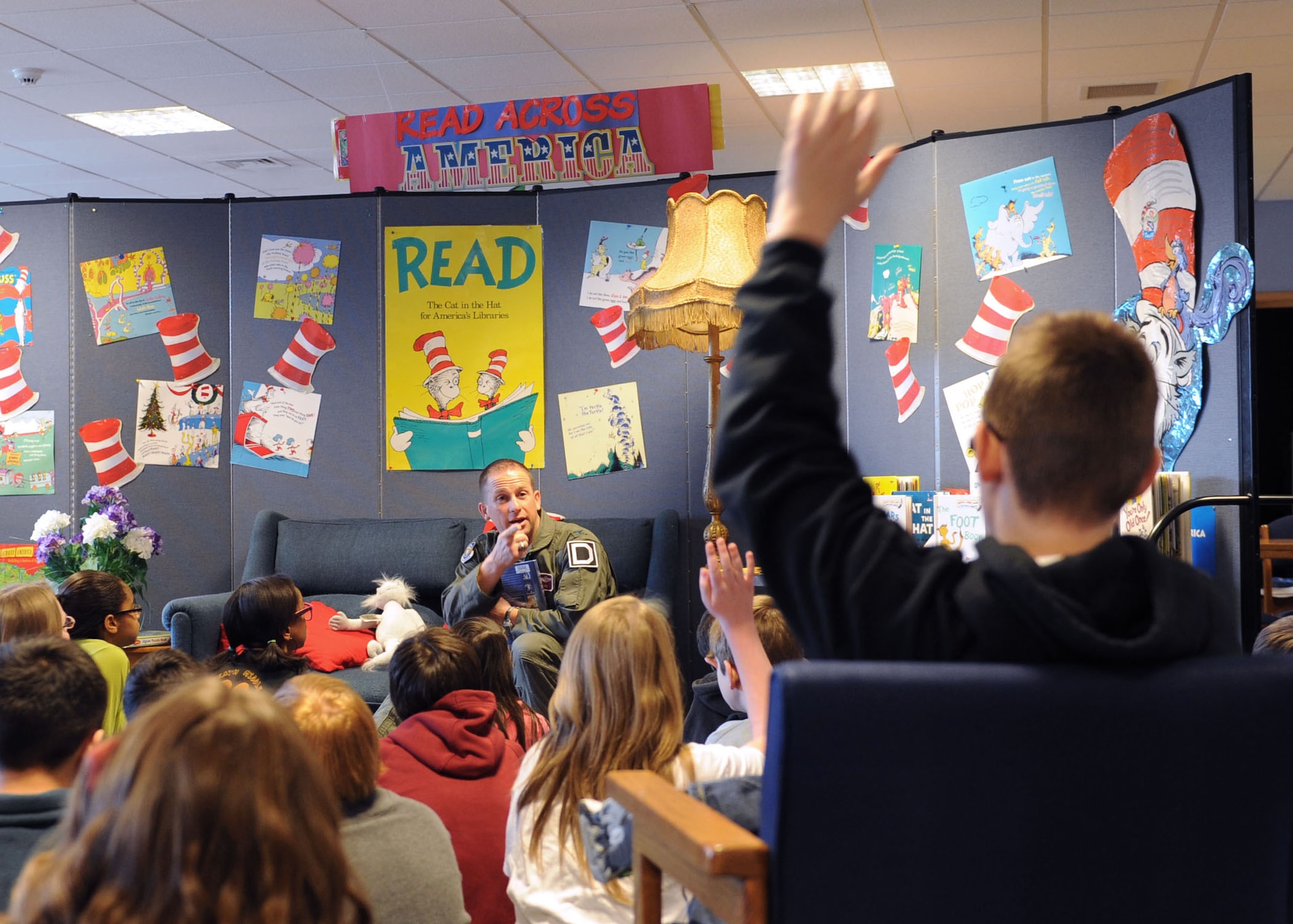 RAF FELTWELL, England – A student asks Col. Kyle Voigt, 100th Air Refueling Wing vice commander, a question March 2, 2012, at Lakenheath Middle School on RAF Feltwell. Voigt was at the school as one of several readers for Read Across America Day. (U.S. Air Force photo/Tech. Sgt. Neal X. Joiner)